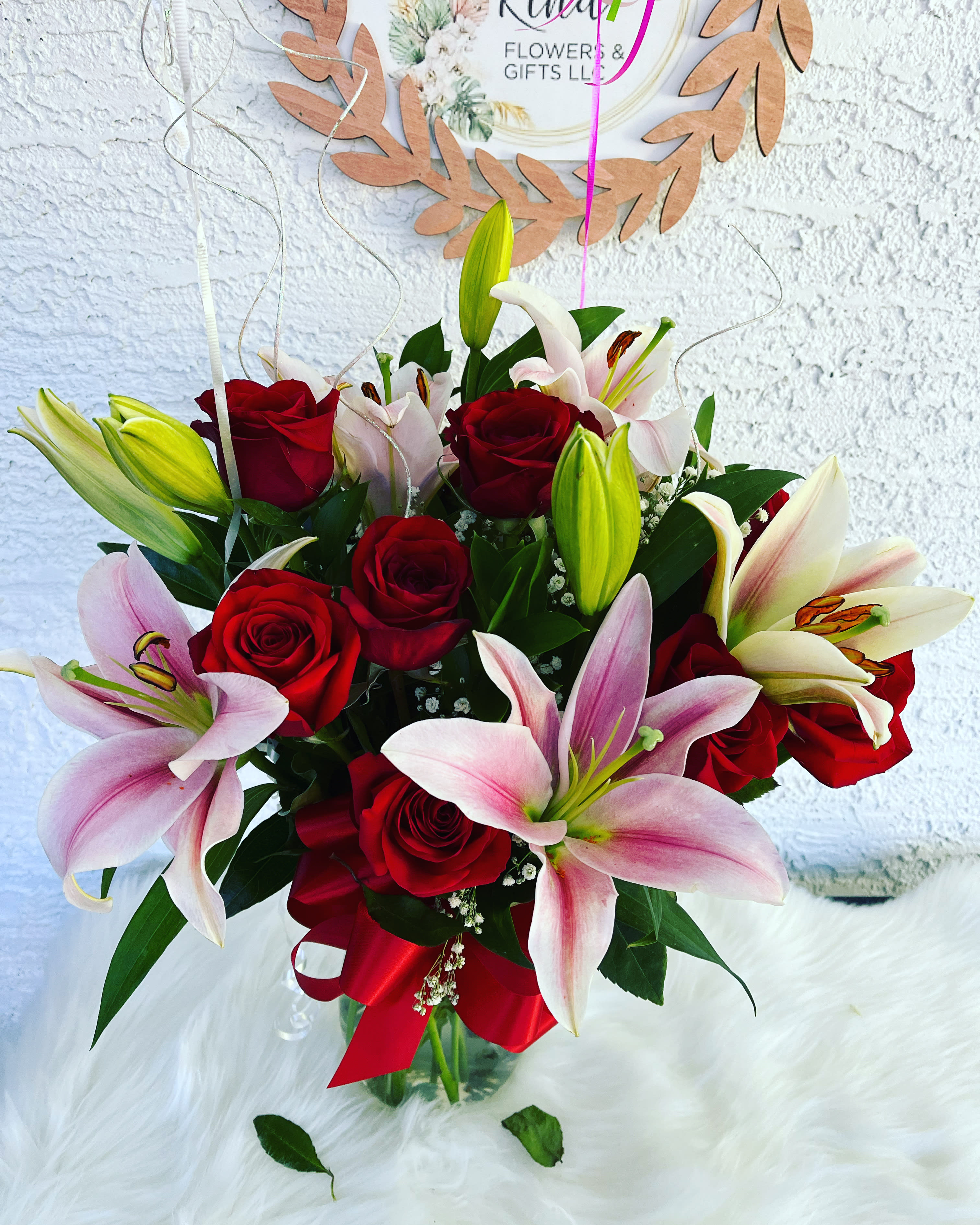 In Love In Love - Dozen red roses and lilies; you can choose the color of roses of your preference. With our special and unique creations we want to touch the heart of each person who receives one of our arrangements. We have put all our talent and love into each and every one of the creations. You are our inspiration.