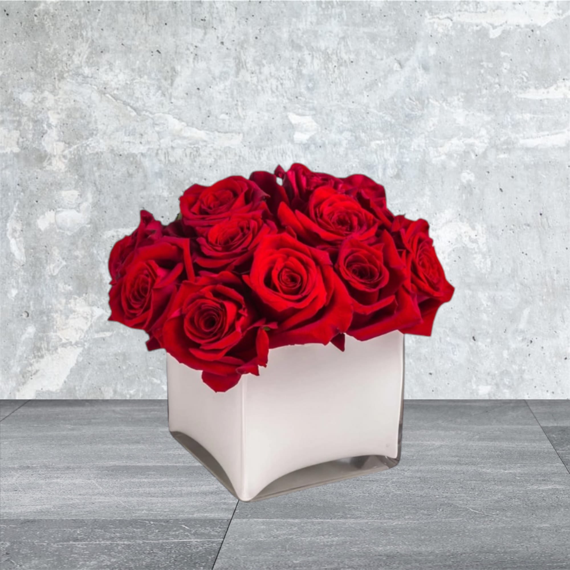 Radiant in Red - This bold yet tasteful bouquet is the perfect size for any desk. Radiant in Red by BloomNation™ makes a great gift for Valentine's Day, a Birthday, or an Anniversary.  Arrangement Details: 12 Red Roses in a White, Cubed Vase APPROXIMATE DIMENSIONS 8&quot; H X 10&quot; L X 8&quot;W