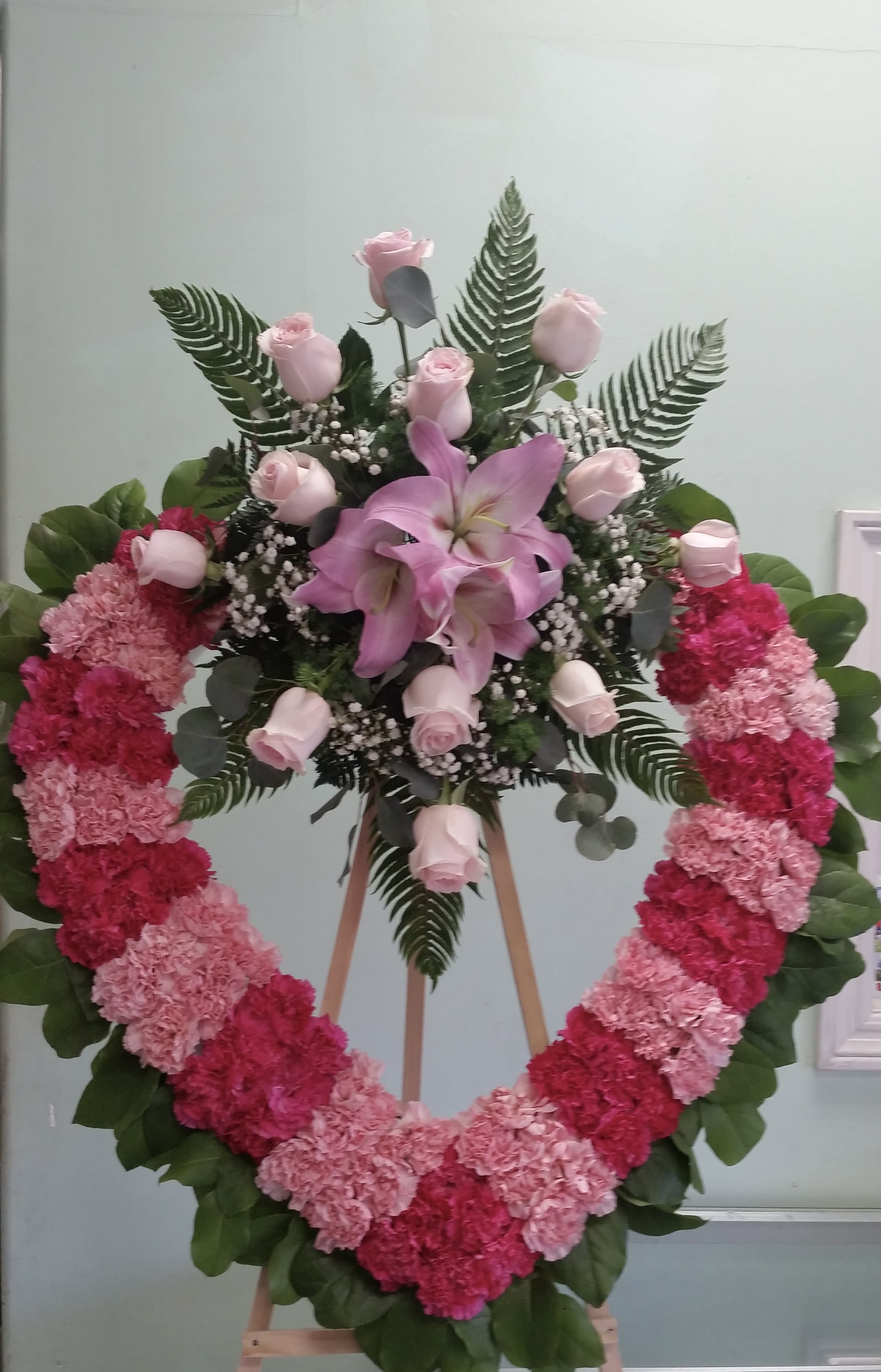 Comforting Pink Heart Comforting Pink Heart - Open heart with hot pink carnations, light pink carnations, light pink roses, and pink lilies.