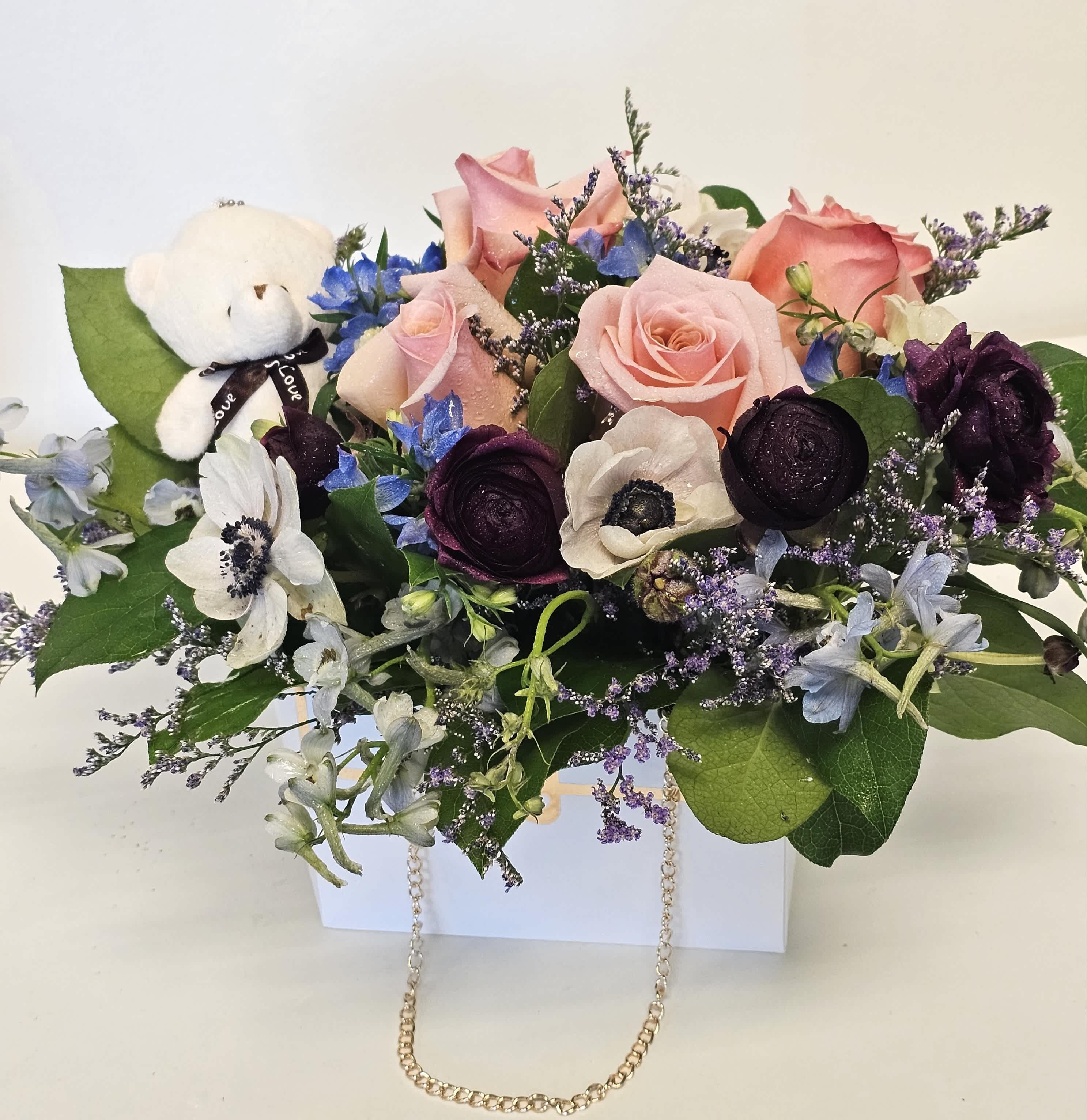 Beautiful arrangement with teddy bear in paper handbag Beautiful arrangement with teddy bear in paper handbag - Delight your loved one with our Beautiful Arrangement with Teddy Bear in Paper Handbag. This charming gift features a bouquet of fresh, vibrant flowers paired with an adorable teddy bear, all elegantly packaged in a stylish paper handbag. Perfect for any occasion, it’s a sweet way to show you care. Add a personal note to make it even more special.