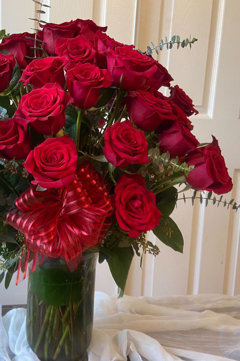 Three Dozen Grandeur Long Stem Red Roses - Indulge in the timeless elegance of our Three Dozen Grandeur Long Stem Red Roses. Each bouquet features 36 of the finest, hand-selected long stem roses, celebrated for their rich, velvety petals and enchanting fragrance. Perfectly arranged, these stunning blooms symbolize love and passion, making them an ideal gift for Valentine’s Day, anniversaries, romantic occasions, or simply to express your heartfelt sentiments.  Each rose is carefully chosen for its quality and size, ensuring a breathtaking display that captures the essence of romance. Presented in a classic vase, this impressive arrangement is sure to make a grand statement. Elevate your special moments with the beauty and allure of our Three Dozen Grandeur Long Stem Red Roses, a bouquet that speaks volumes without saying a word.