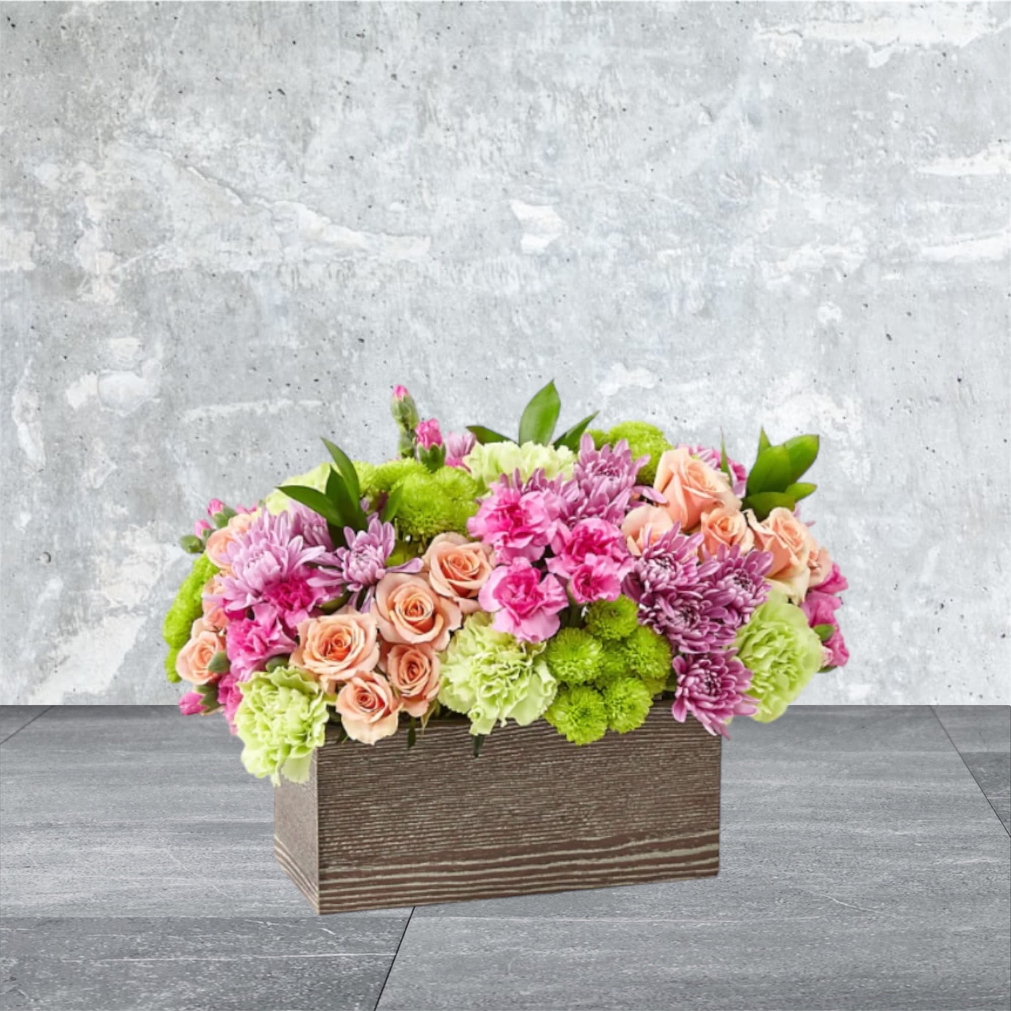 Mellow Garden - Our mellow garden is filled with an assortment of button pom, carnations, and spray roses. 