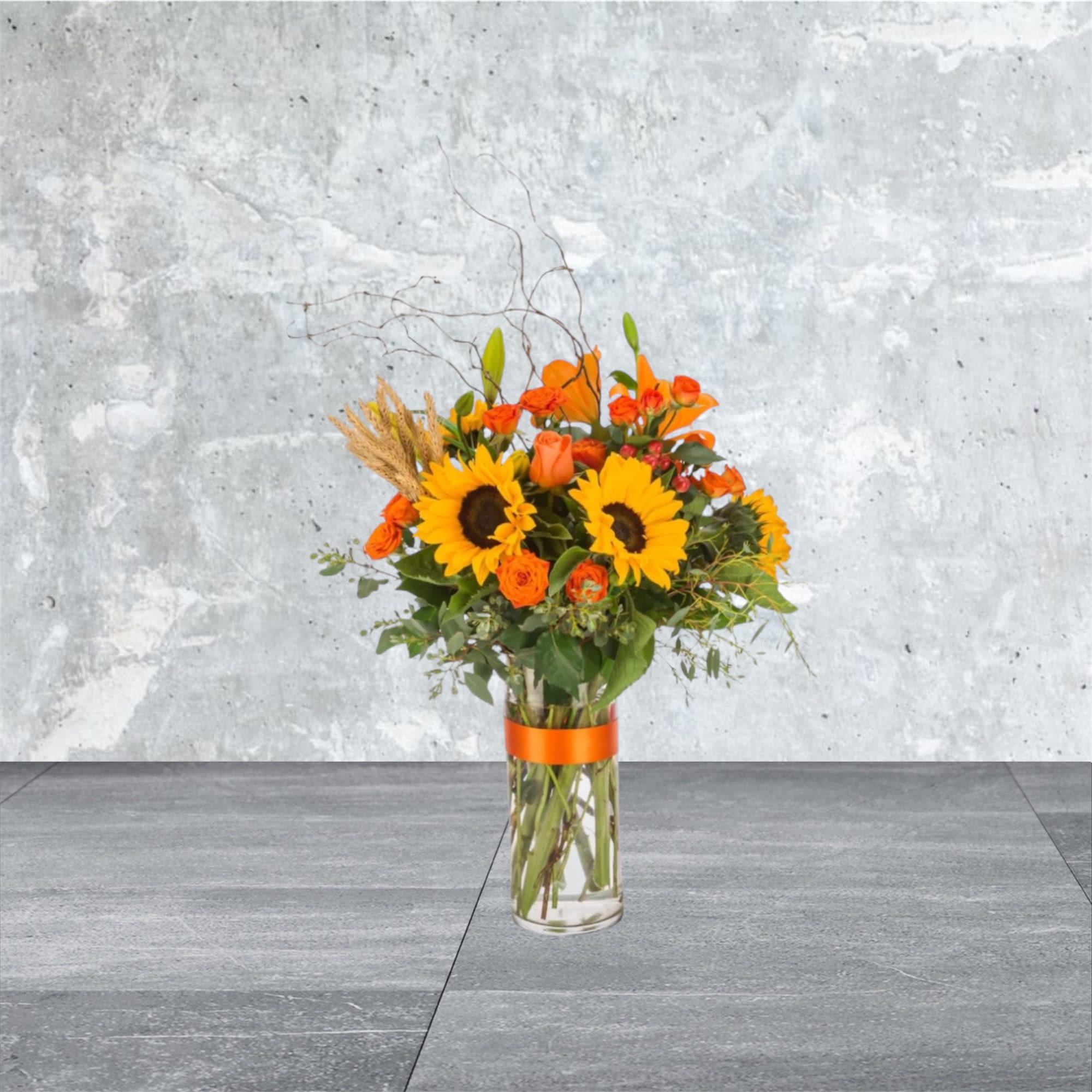 Hayride - The ultimate fall flower mix featuring sunflowers and a variety of orange flowers with eucalyptus and curly willow accents. Send this arrangement for Halloween, Thanksgiving, or to celebrate the season!  Approximate Dimensions: 18&quot;D x 29&quot;H
