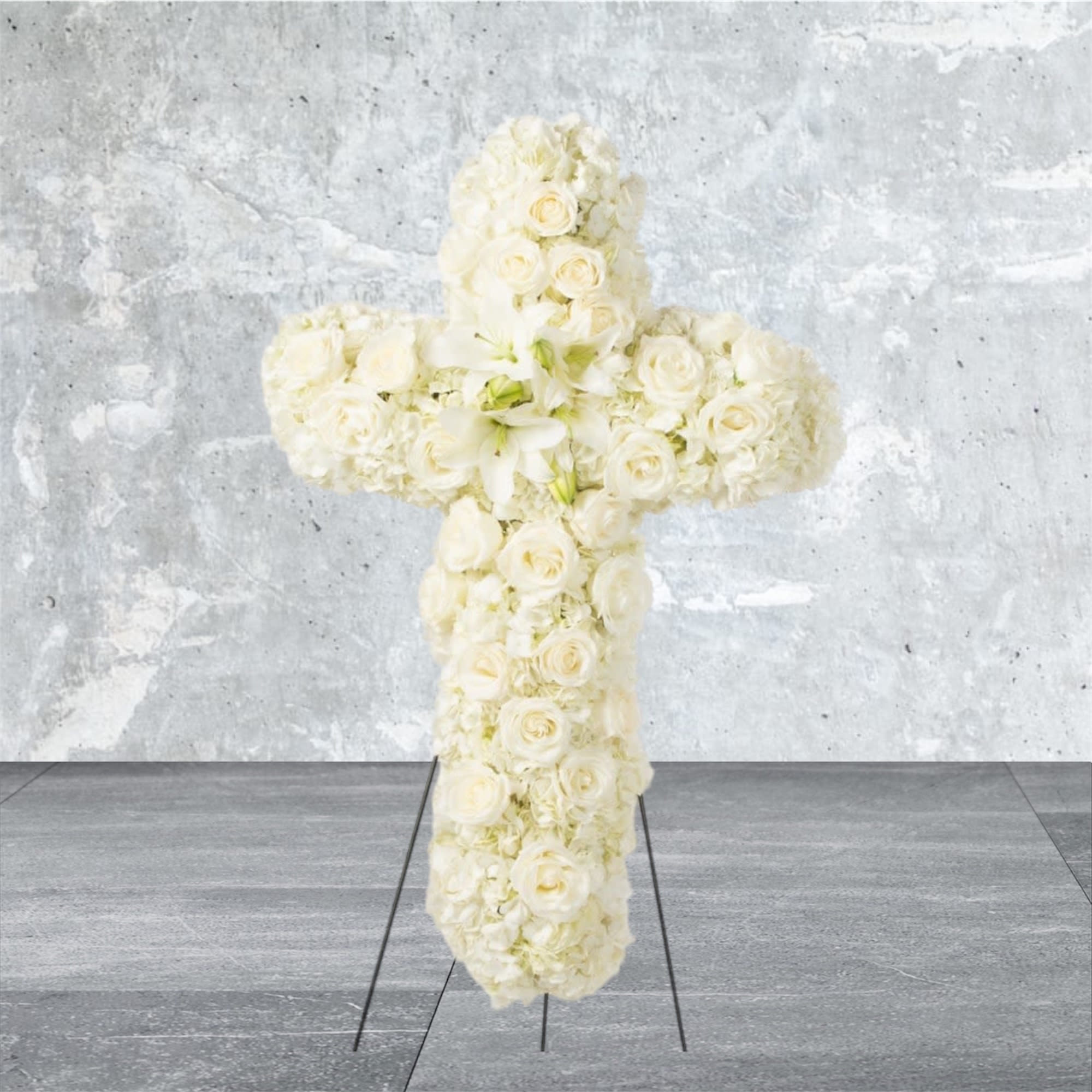 Faith - An all white tribute, this white cross funeral spray is pure and tranquil. Featuring a variety of white flowers, this elegant easel compliments the beauty of life. 