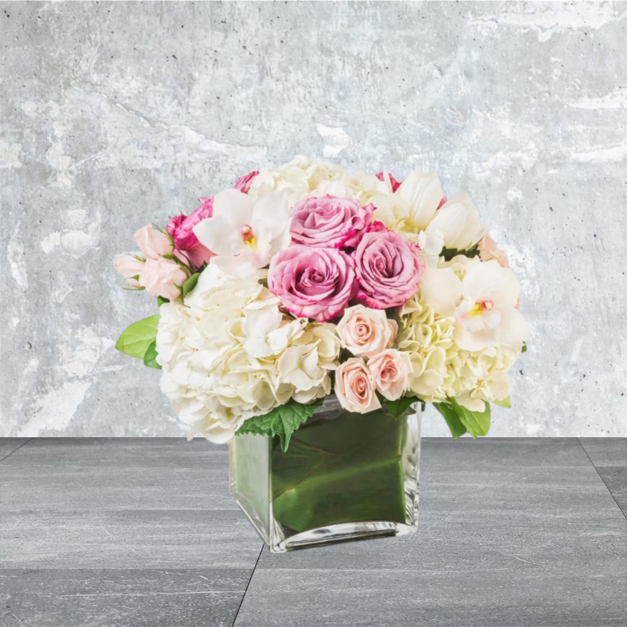Carolina - Classic and Beautiful, this large arrangement whispers luxury. Soft pinks, whites and creams come together to create an appealingly feminine gift. Perfect for welcoming a new baby, wishing happy birthday or saying congratulations.   APPROXIMATE DIMENSIONS: 15&quot; W X 15&quot; H    