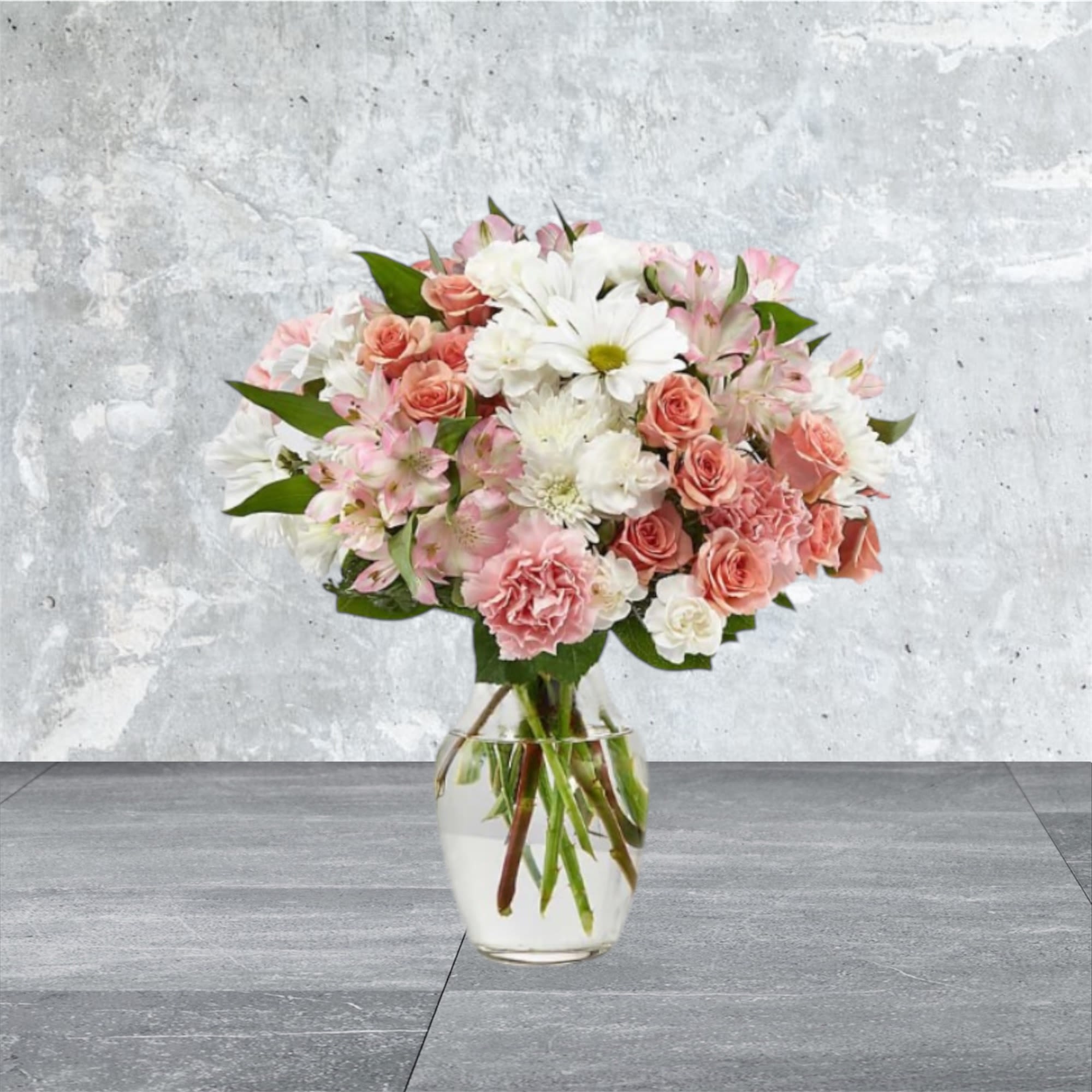 Blushing Blossom - A pastel pink and white arrangement with alstroemeria, spray roses, carnations, and daisies. 