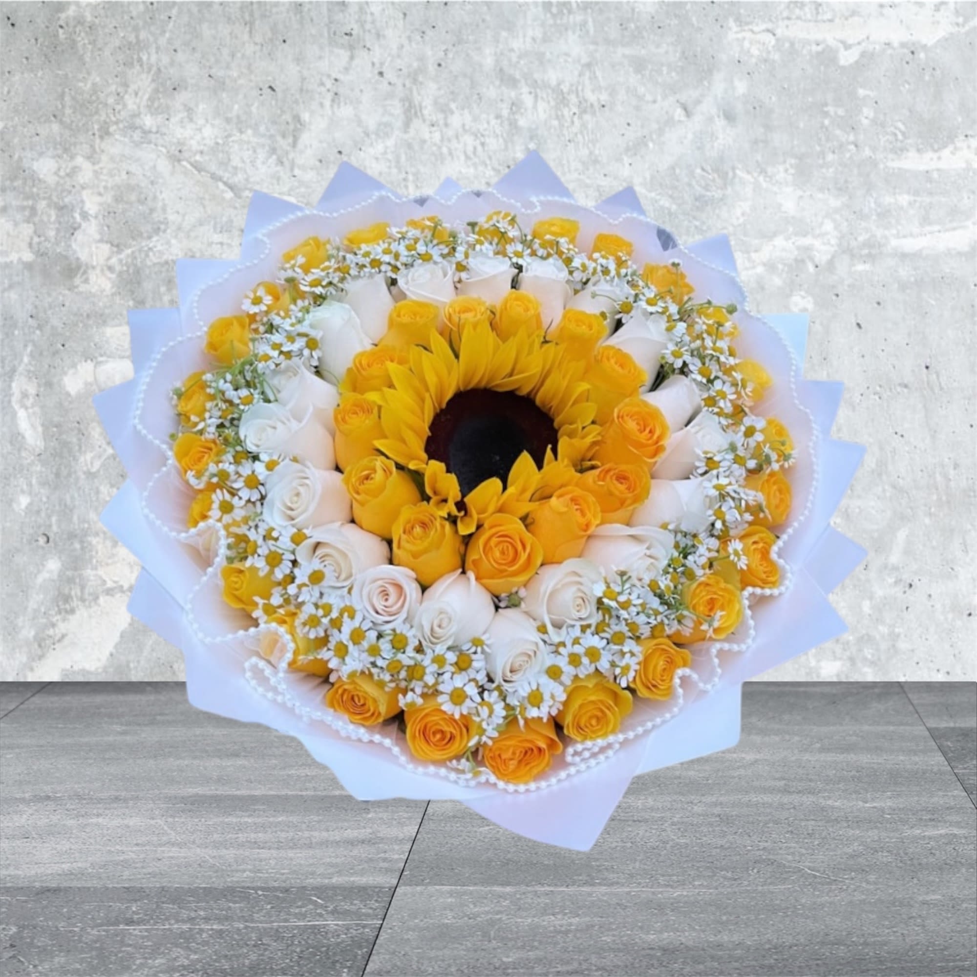 Morning Dew - A refreshing assortment of white daisies, white roses, yellow roses, and a sunflower center. This bouquet brings the crisp, clean feeling of a dewy morning into your home, brightening up any room with its cheerful and fresh appearance.  Disclaimer: The picture provided is our premium size