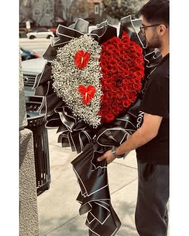 cheek Heart Rose - Picture shows the Premium Elevate your gift-giving with our stunning and perfect blend of elegance and emotion. This exquisite heart-shaped floral masterpiece is thoughtfully crafted to convey your deepest sentiments. We accept customized arrangements as well. The arrangement contrast of vibrant red roses and delicate white baby's breath, symbolizing love and purity. The red roses, meticulously arranged on one half of the heart, radiate passion and admiration. On the other half, the soft baby's breath provides a gentle, airy balance, adorned with two eye-catching red anthurium flowers that add a touch of exotic charm.