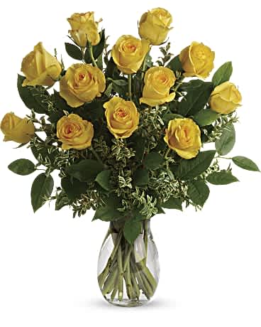 Say Yellow Bouquet - Here comes the sun! Say hello to a happy day with this grand bouquet of a dozen yellow roses and fresh greens in a graceful glass vase. This sunny arrangement features 12 yellow roses with oregonia and lemon leaf. Delivered in a glass jordan Vase.