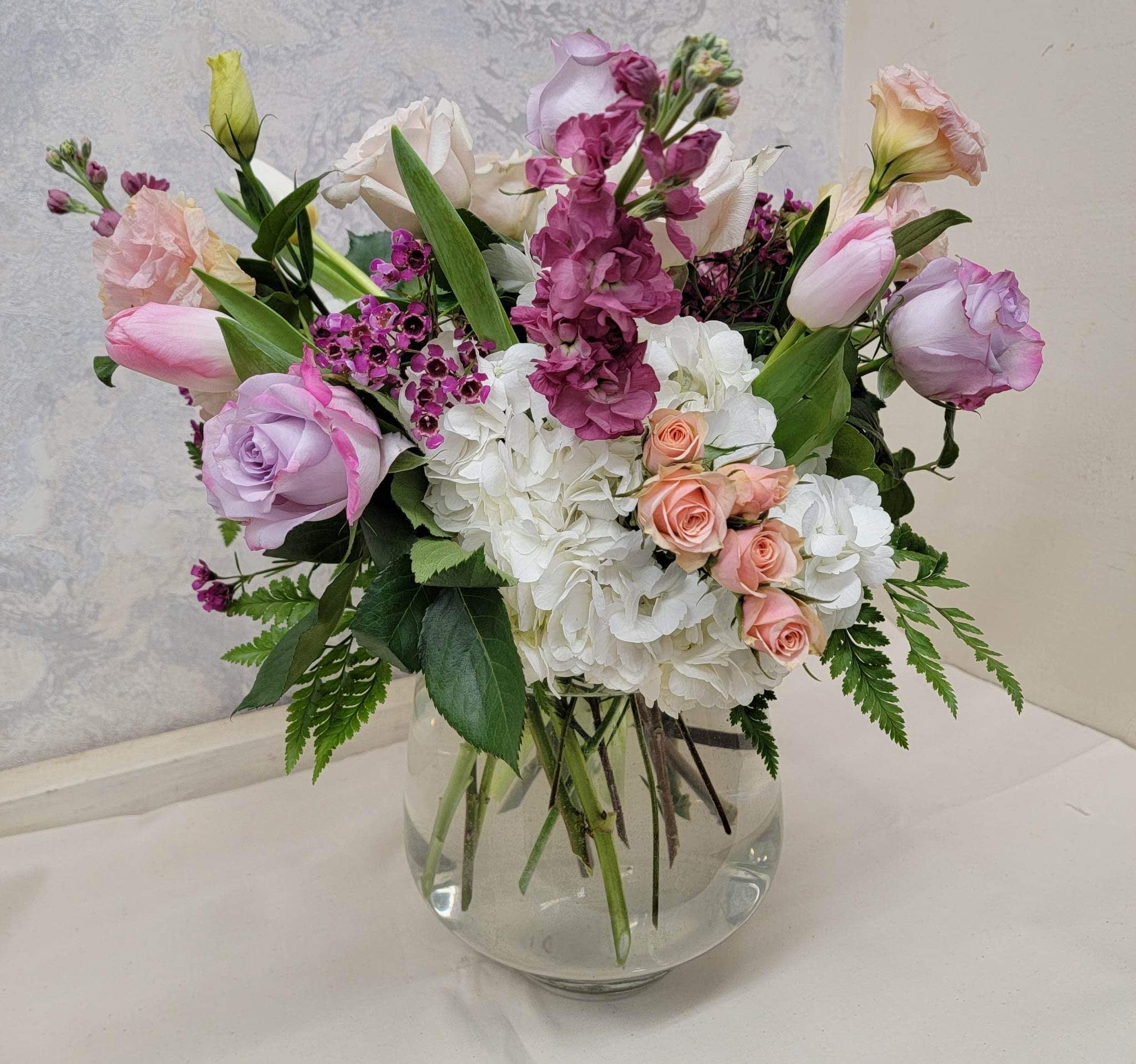 Pretty in Pastel - A variety of garden flowers in pastel colors arranged in a large ginger vase. 