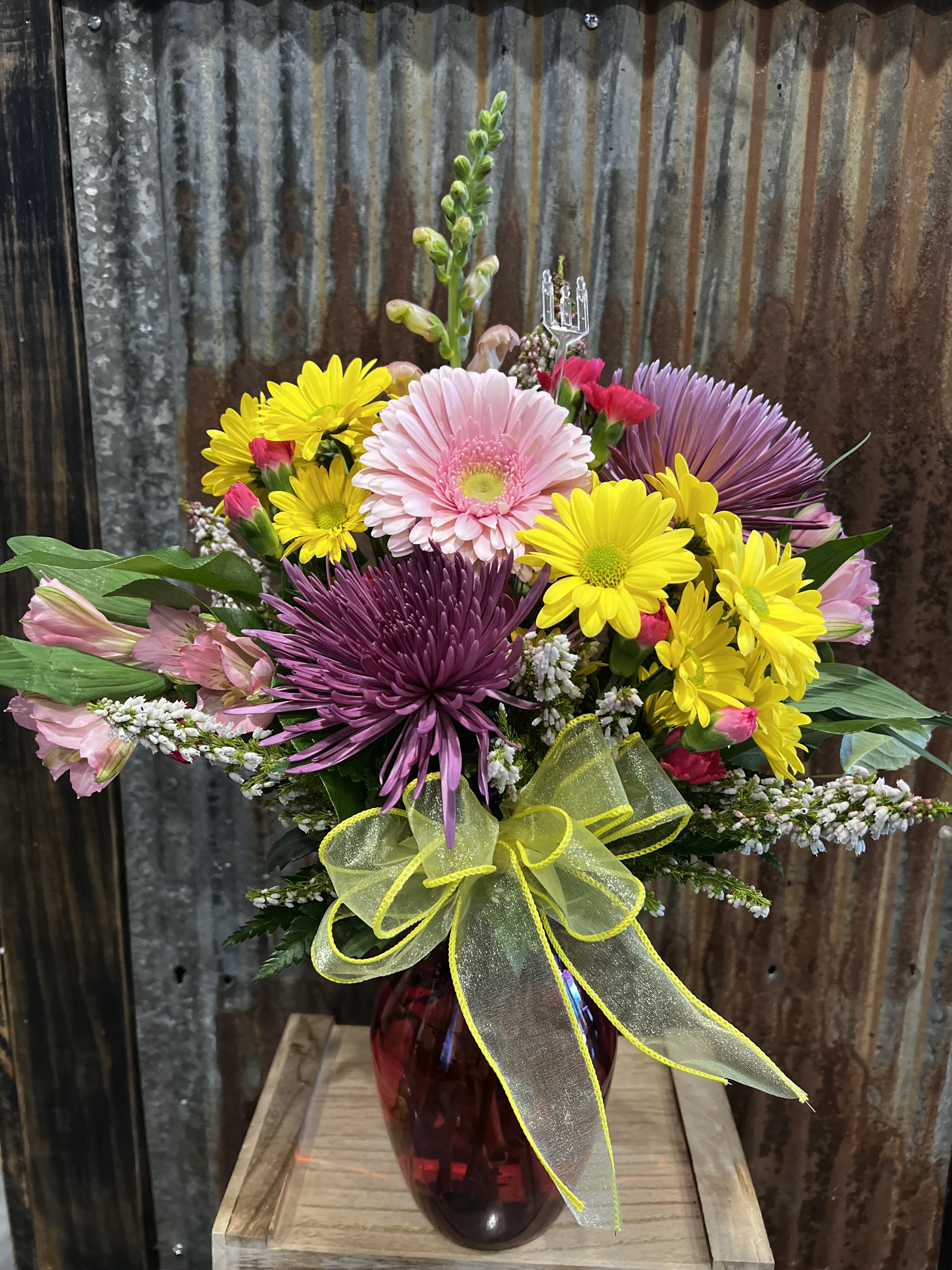 Bright Bold Beautiful  - An array of bright colored flowers arranged in a colored vase 