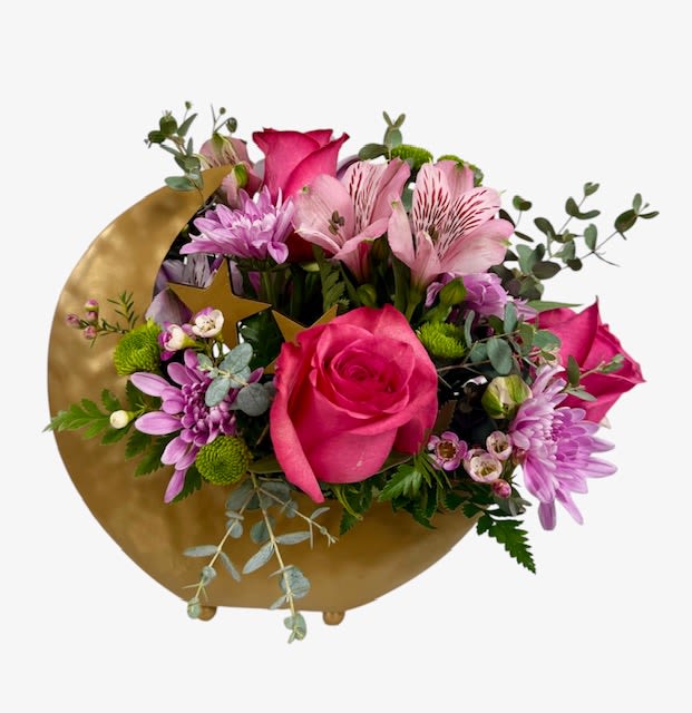 Over the Moon for You - This adorable keepsake moon with star accent container is perfect for your someone special! The arrangement is a mix of pinks and lavender using roses, alstroemeria, chrysanthemums and buttons.