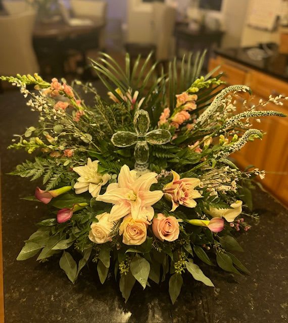 Treasured Memories by Deanna Treasured Memories by Deanna - Round traditional filled with stargazer lilies, Cala lilies, Mondial Roses, Veronica, white Ginestra, Pink snapdragons,Palms, seeded Eucalyptus, Italian Ruscus. added Crystal cross (styles vary)