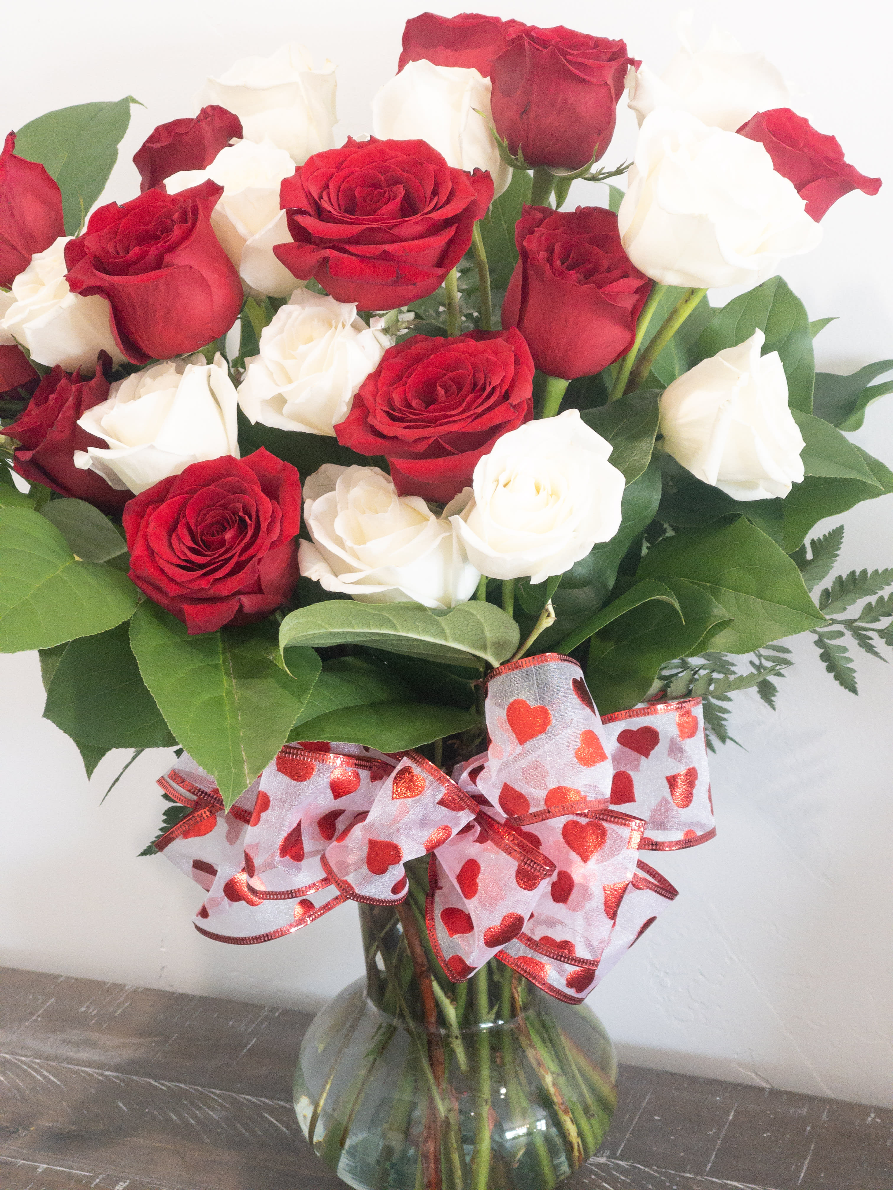 ALWAYS AND FOREVER ALWAYS AND FOREVER - 2 Dozen Long Sten Roses arranged in a beautiful vase with fill.