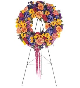 Celebration Wreath [TF203-10] - This beautiful wreath with its distinctive orange, yellow and blue flowers, will offer your regards in the warmest way.  One wreath arrives on a easel filled with orange roses, yellow spray chrysanthemums, blue hydrangea, red amaranthus and purple asters.  Approximately 15&quot; D      As Shown : TF203-10  