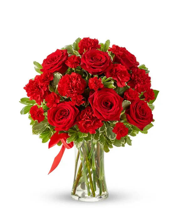 You Are My Heart - Let your love bloom with this beautiful, lush bouquet. This all red flower arrangement is hand-arranged by a local florist near you with classic red roses, along with red carnations. All the red flowers make this gift a wonderful way of letting someone in your life know they are important to you and you appreciate all the love they give you. The red roses and carnations are delivered in a clear glass vase with a red ribbon tied around the center.