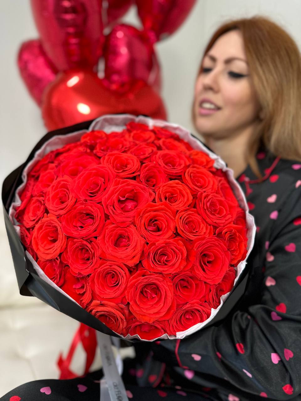 Red in black bouquet  - Gorgeous red roses in a black wrap Standard - 48-50 roses  Deluxe - 73-75 roses Premium - 98-100 roses