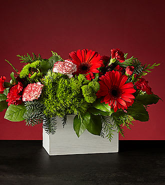 HOLLY JOLLY BOUQUET HOLLY JOLLY BOUQUET - WOODEN BOX FILLED WITH EVERGREENS, RED GERBERA, PEPPERMINT CARNATIONS, RED AND MINI CARNATIONS
