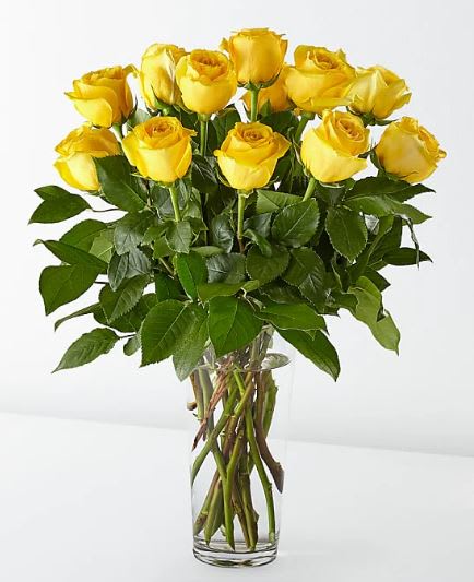 12 Long Stem Yellow Roses - The FTD Yellow Rose Bouquet is a spectacular way to offer hope and warmth to those facing the loss of a loved one. Sunlit yellow roses are arranged with seeded eucalyptus in a clear glass vase to create the perfect gift of caring kindness that expresses your deepest sympathies.