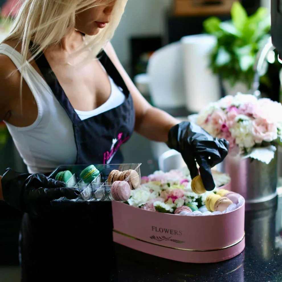Macaroons with flowers - Charming roses and mix flowers along with macaroons, are collected in a heart-shaped box. Primary colors are white, pink, yellow and purple. This is the best flower arrangement for any occasion!
