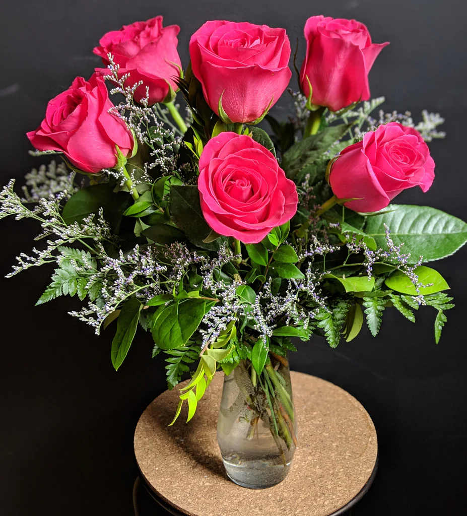 Hot Princess Roses - The perfect gift! One dozen elegant long-stemmed roses tastefully arranged with babies' breath or similar acccents and fresh foliage. 