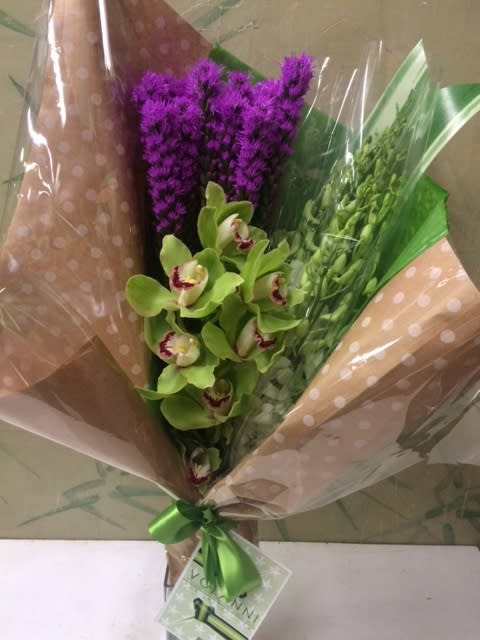 Designer's Choice Bouquet Designer's Choice Bouquet - Freshest stems we have in stock to make this wrapped bouquet. The photo does not necessarily represent the flowers, colors, or design, depending on our stock items. The bouquet will represent Volanni's style. Starting at $75 and up.