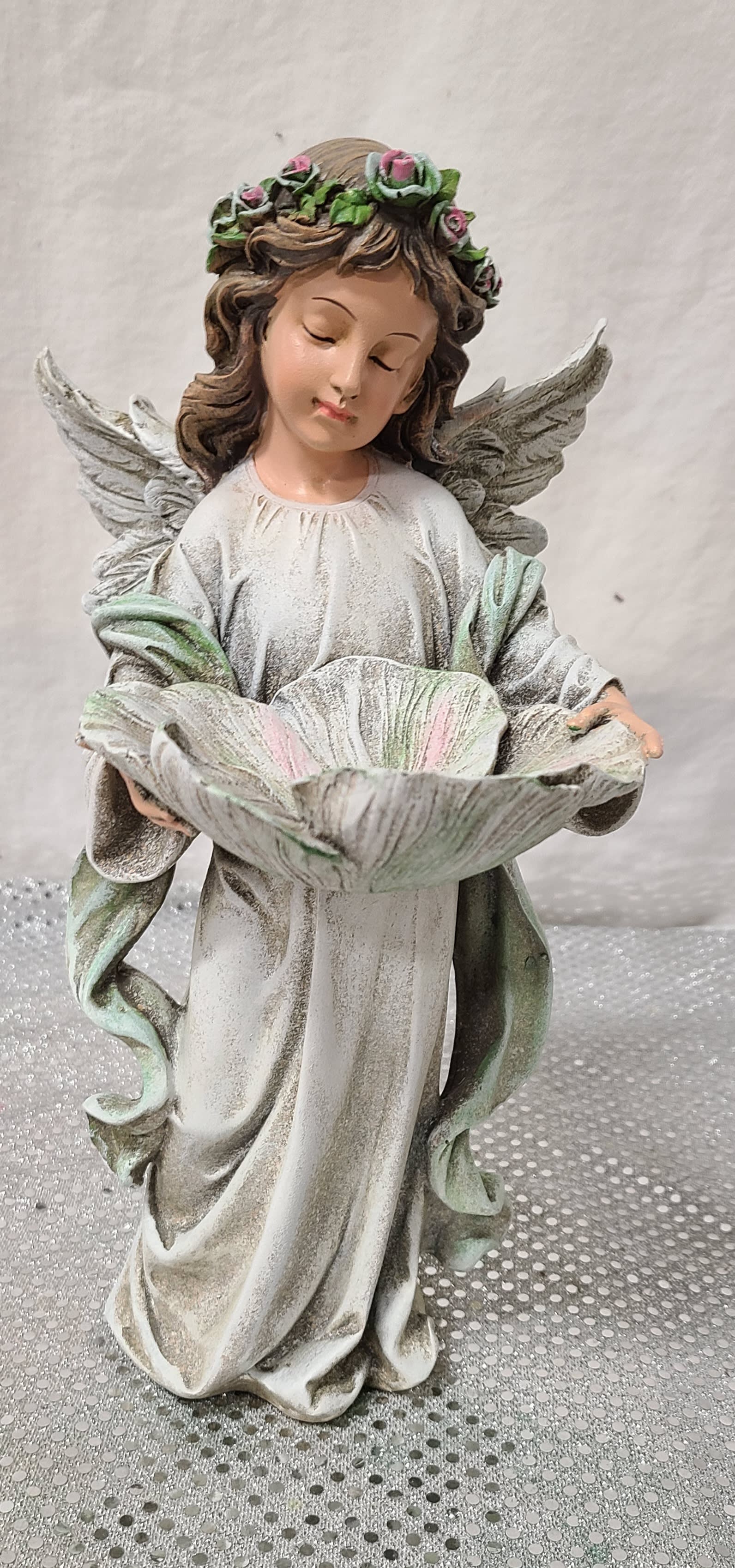 Angel with Bird Feeder Angel with Bird Feeder - This Angel stand about a foot tall and is made out of the resin material. Can be added with flowers or plants.