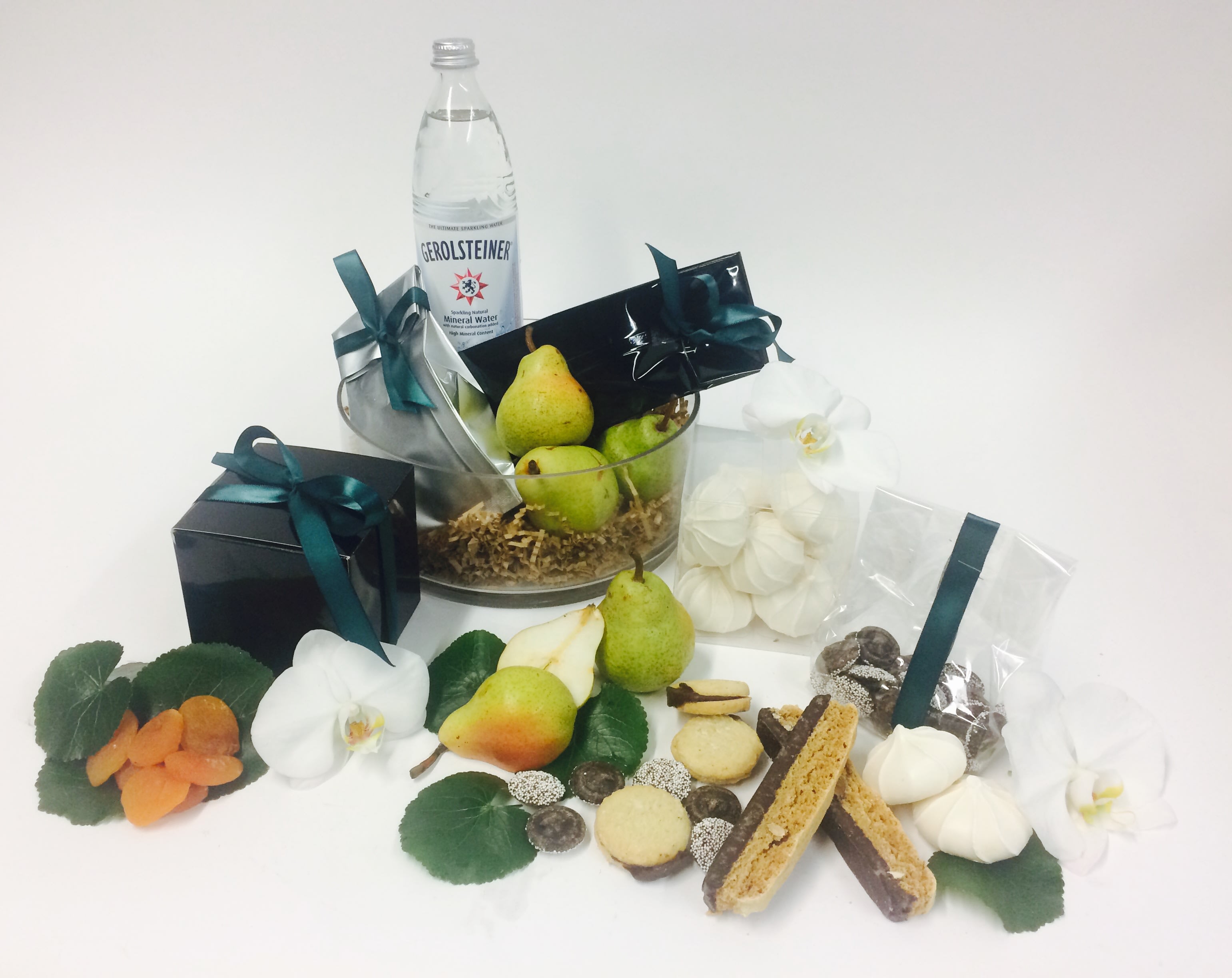 Modern Don Modern Don - ***This is available for next day delivery. We use the freshest seasonal elements, so substitutions may be made. But the overall look remains the same. Modern glass fruit basket, seasonal fresh and dried fruits, sparkling water, cookies, chocolate.