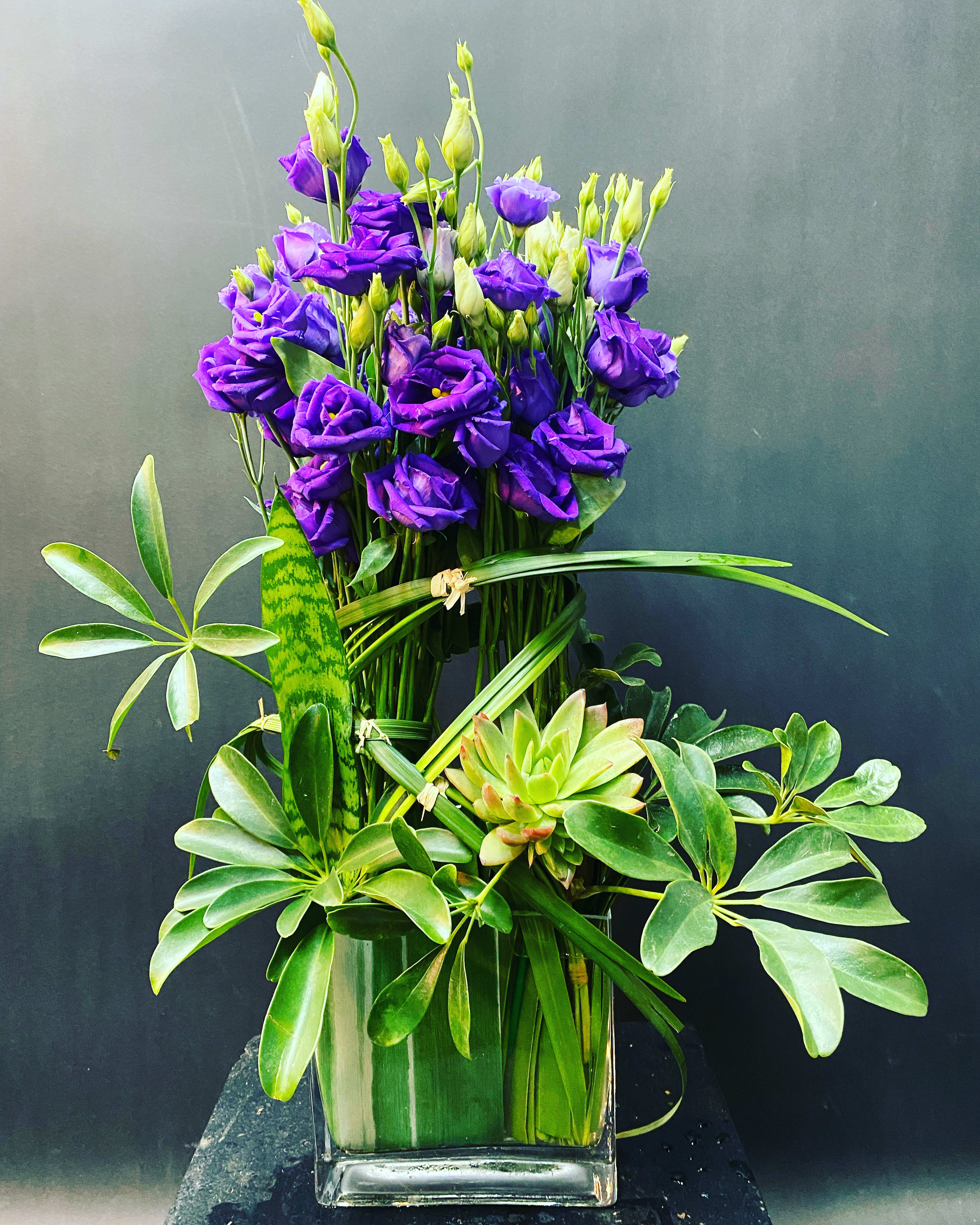 PURPose PURPose - ***This is available for next day delivery. ***We use the freshest, seasonal flowers available. Substitutions may be made. Purple lisianthus, succulent.