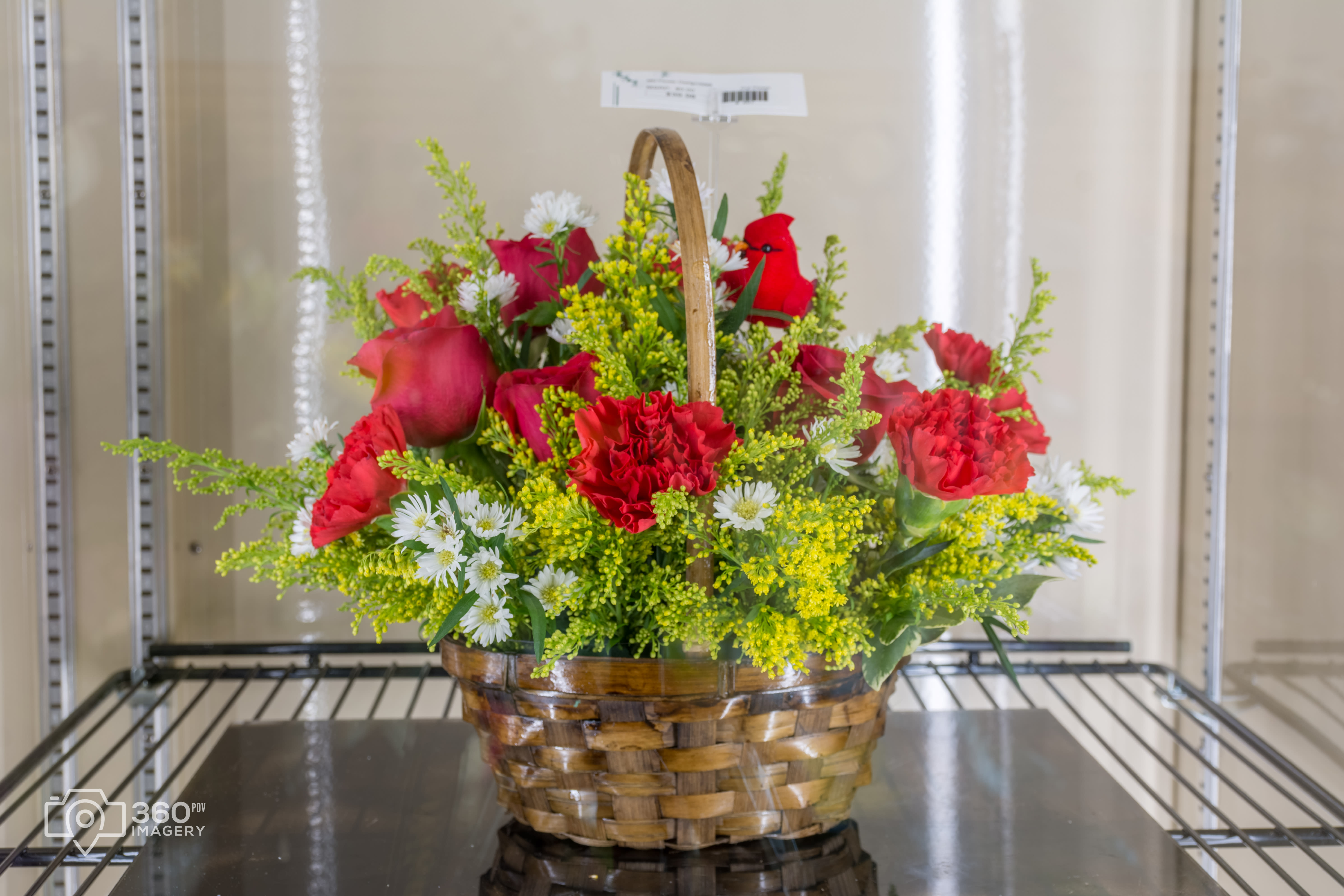 Red Bird N Basket  - Red roses, red carnations, yellow solidago, white monte casino aster, in brown wicker basket accented with red bird