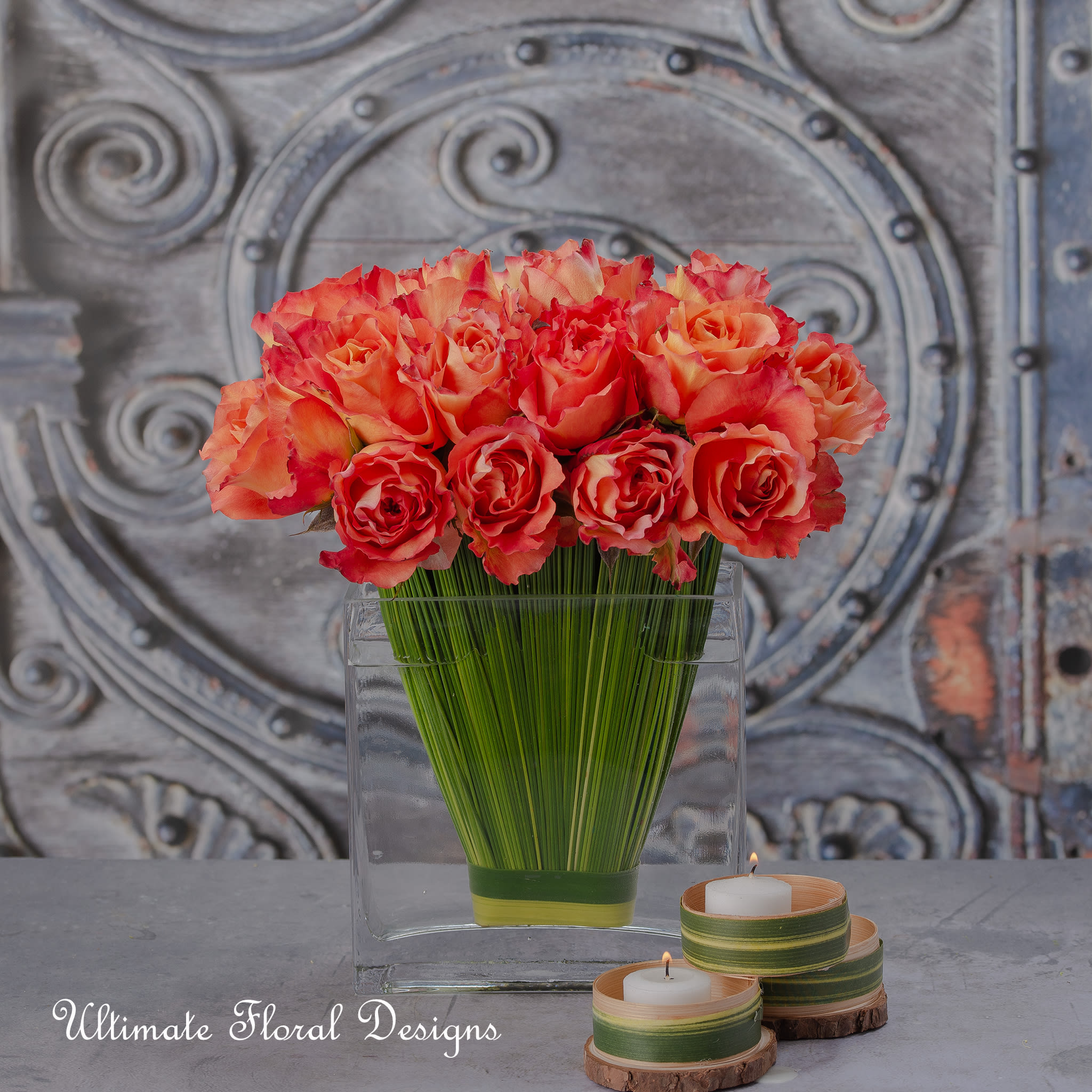 orange paradise - “Take time to smell the roses.” – Proverb This stunning floral design offers you the perfect orange roses and unique composition of 18 stunning orange  roses form into a pavé, while bear grass is shaped into a v at the base.