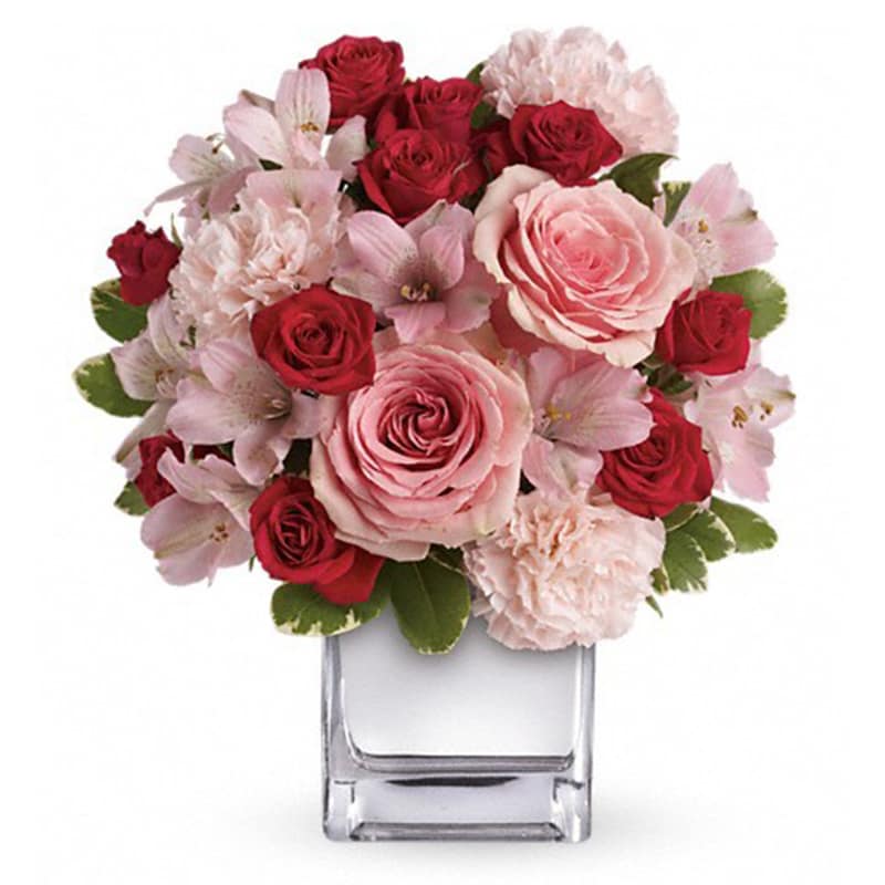 Love That Pink Bouquet with Roses [T409-3A] - Passionately pretty in pink, this gorgeous array of pink and red roses and other favorites in a chic mirrored silver cube is a guaranteed heart-winner. She'll be thrilled with the gift, and knocked out by your impeccable taste.  This exquisite bouquet includes pink roses, red spray roses, pink alstroemeria and pink carnations accented with assorted greenery. Delivered in a mirrored silver cube.  Approximately 11&quot; W x 12 1/2&quot; H  THIS ITEM WILL NOT BE AVAILABLE FEB 10TH-15TH.  SIMILAR ARRANGEMENTS FOR THESE DATES CAN BE FOUND IN THE VALENTINE’S 2020 SECTION.
