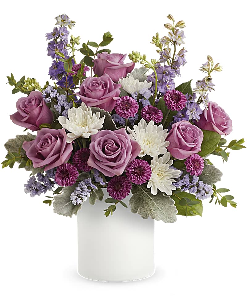Playfully Yours Bouquet Playfully Yours Bouquet - A playful spin on the classic rose bouquet, these lovely lavender blooms look fun and flirty in this frosted white glass jar. Lavender roses, purple button spray chrysanthemums, white cushion spray chrysanthemums, lavender larkspur and lavender sinuata statice are arranged with dusty miller, parvifolia eucalyptus and lemon leaf. Delivered in Teleflora's Savannah Jar. Orientation: All-Around SUBSTITUTION POLICY – Always deliver the freshest flowers! Please note the bouquet pictured reflects our original design. If the exact flowers or container in this arrangement are not available, our local florists will create a beautiful bouquet with the freshest available flowers.