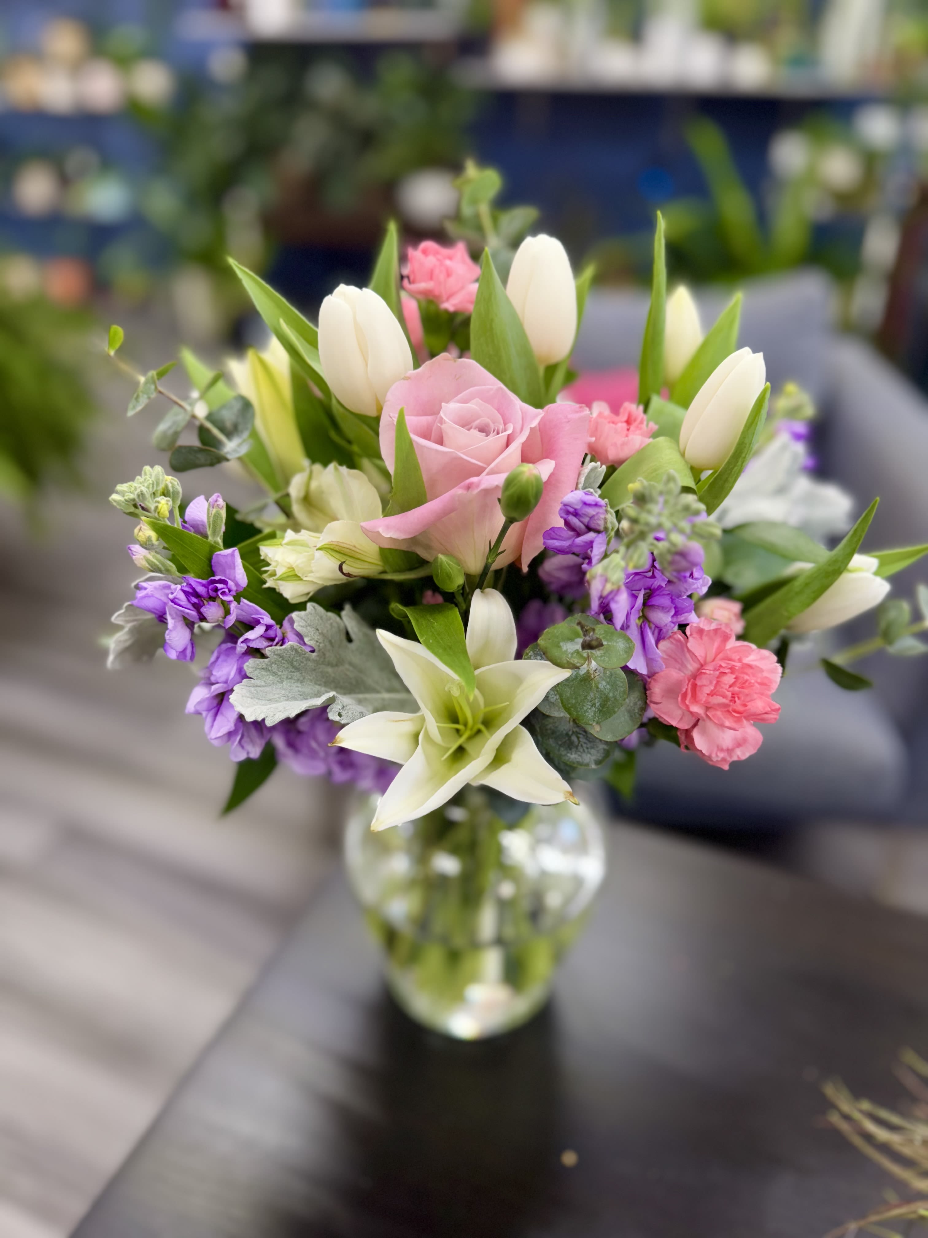 Sweet Harmony  - Sweet Harmony. A delicate composition of soft pink roses, white tulips, and creamy lilies, accented with lilac-toned flowers and lush greenery. Ideal for conveying tenderness and elegance on any occasion. 17”h x 13”w 