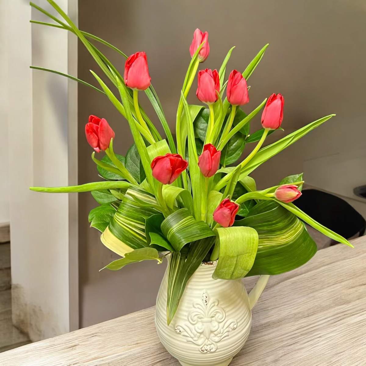 Pitcher of Tulips - Brighten any space with our fresh tulips arranged in a stylish ceramic pitcher.