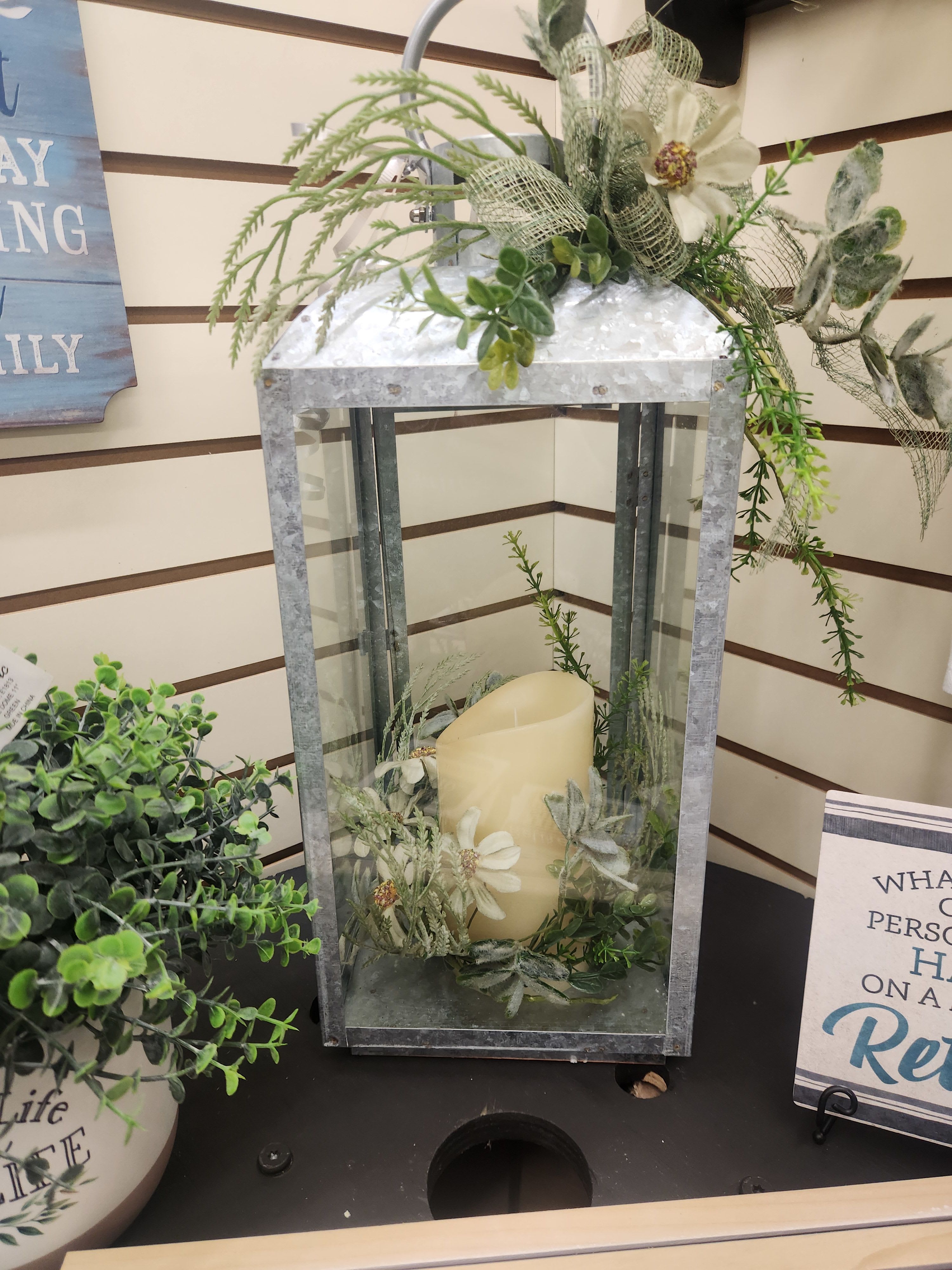 Large Galvanized Memorial Lantern Large Galvanized Memorial Lantern - Large galvanized memorial lantern with silk flowers and a battery-operated flickering candle to represent the memory of your loved one.