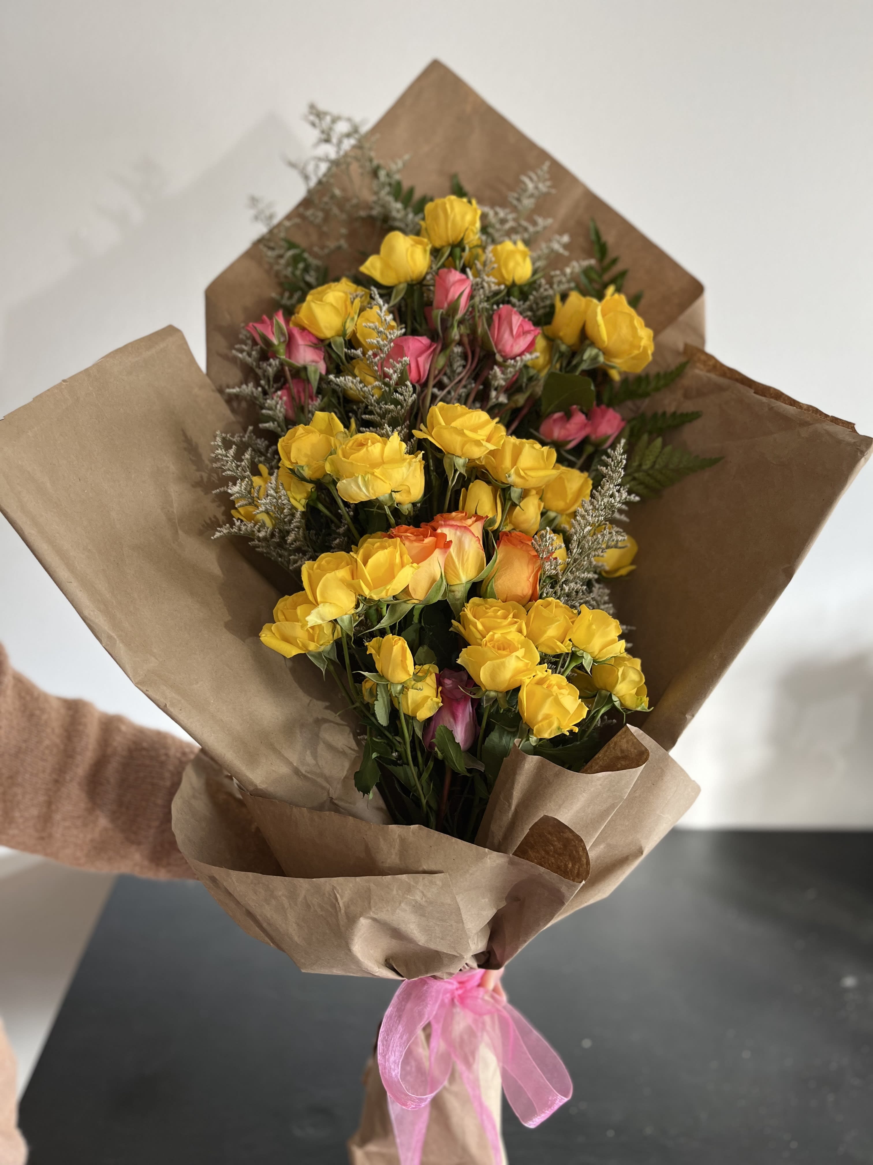 Spray Rose Bouquet  - Wrapped Spray Rose bouquet with yellow spray roses, pops of pink and orange roses, with leather fern and misty white limo as the foliage. *Can be made with different color spray roses as well*
