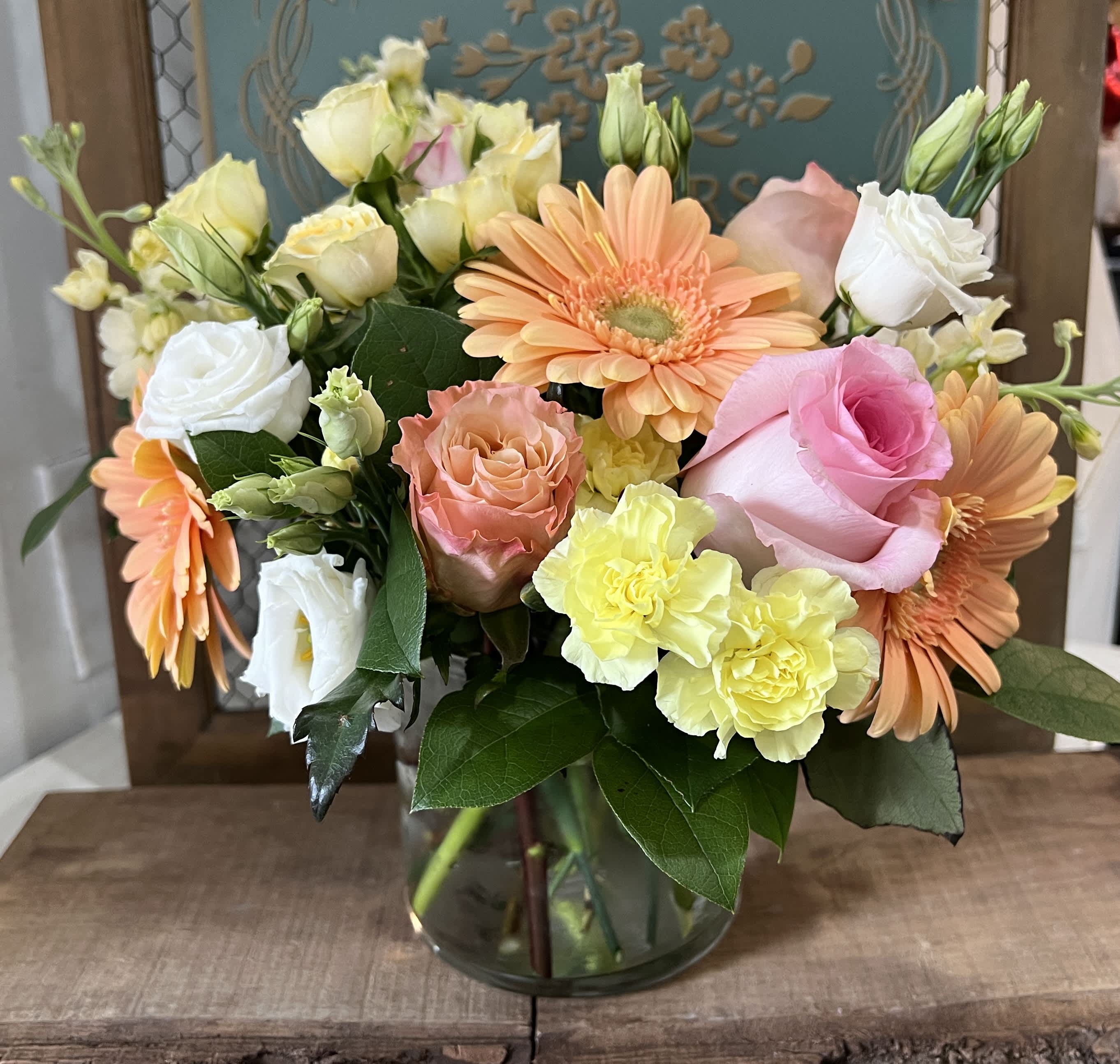 Sunrise Serenade - This arrangement includes peach and pink  roses, gerbera daisies, stock, and lemon leaves. Spring Fever is the perfect gift to wish someone a happy birthday or to say thank you.  Delivery minimum is $50.00 Our DELIVERY SERVICE IS TILL 3 PM We cannot guarantee requests for a specific time of delivery. There might be flower substitutions, due to low supply of certain flowers. However, we do our best to provide you with the same look and feel of the arrangement. Our main goal is to always give our customers quality flowers and service. To make sure that you get the exact same flowers, ordering a few days ahead of desired delivery date is key.