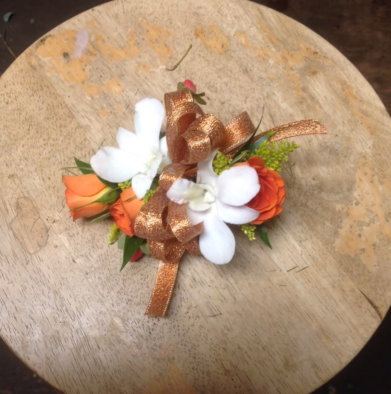 Corsage #4 Corsage #4 - A beautiful corsage with orange spray roses and white dendrobium orchids.