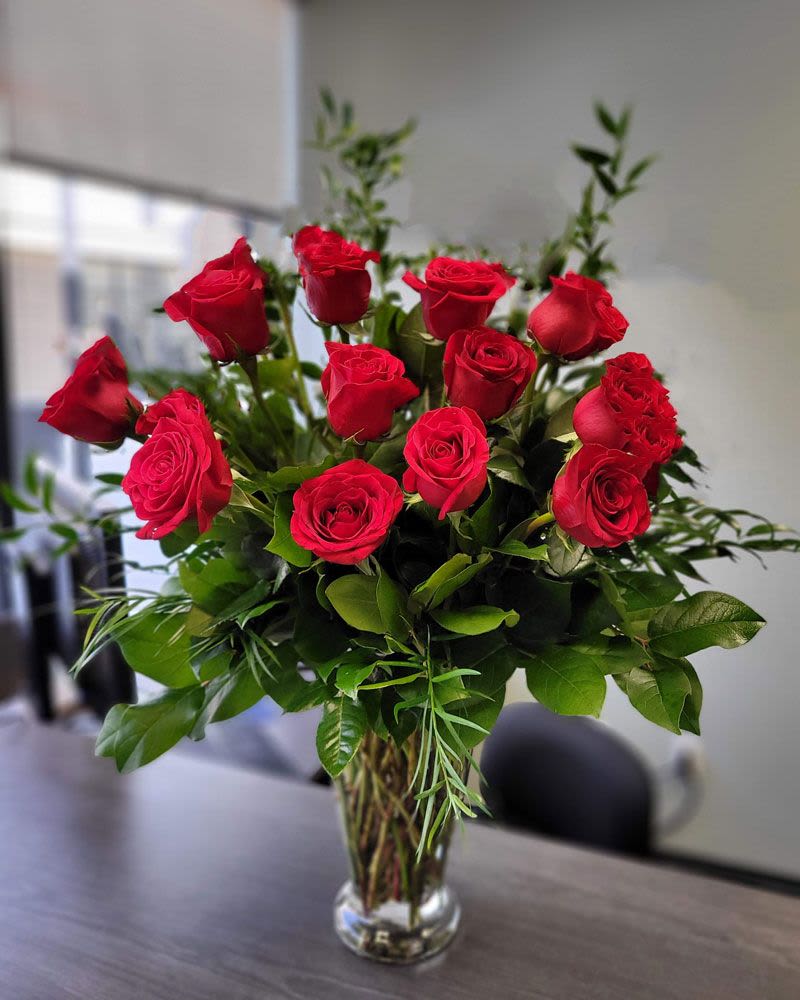 Premium dozen red roses in the vase - Love them with roses today and always. No matter what occasion you can always enjoy our long lasting premium long stem roses in a glass passion  vase.