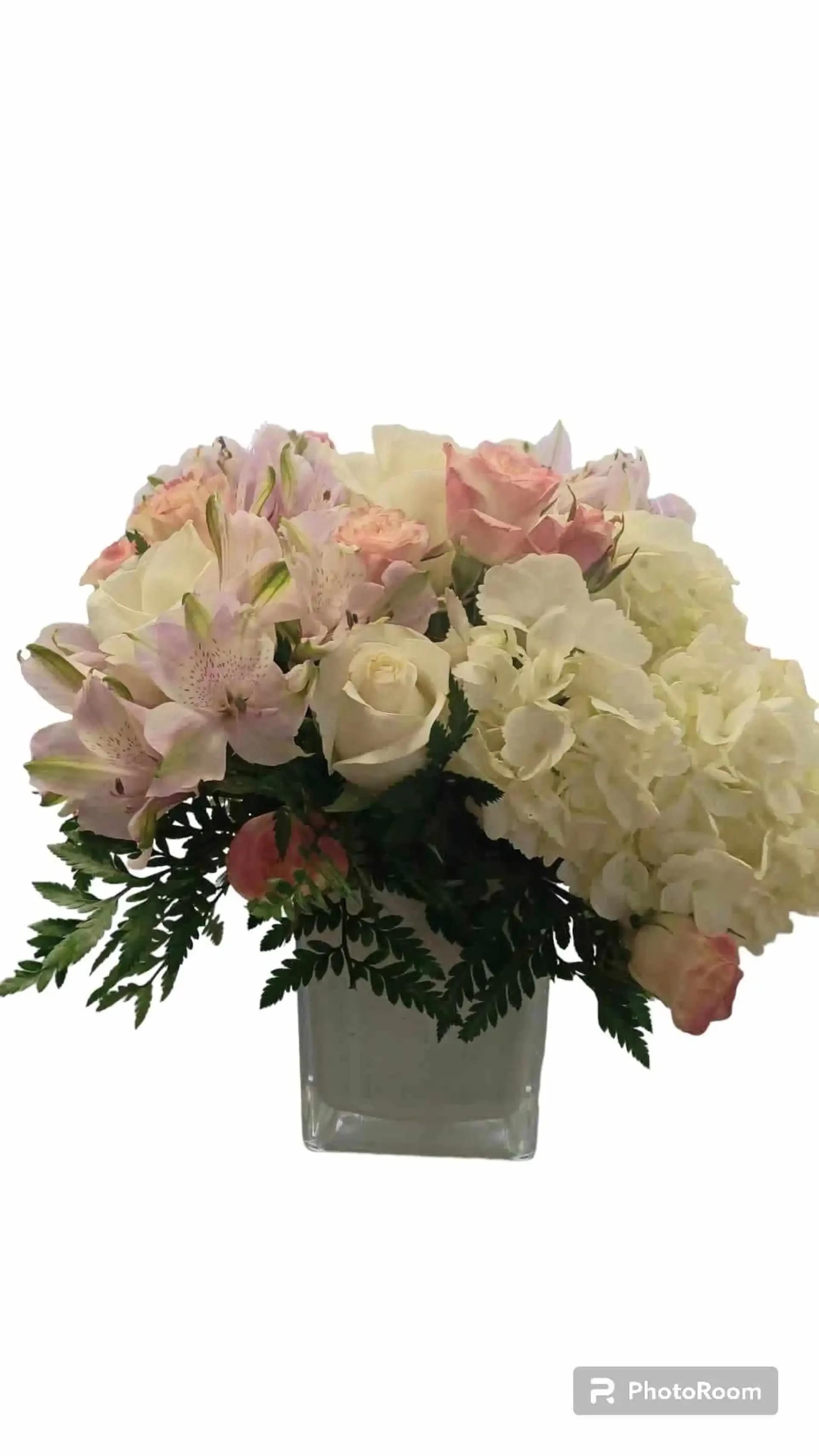 Bright an Beautiful  - Bright and Beautiful&quot; is a stunning and joyous birthday flower arrangement that embodies the spirit of beauty and celebration. This enchanting composition features the soft blush of pink alstroemeria, the delicate charm of pink roses, the classic elegance of white roses, the lush beauty of white hydrangea, and an assortment of verdant green blooms. With its captivating colors and exquisite presence, &quot;Bright and Beautiful&quot; is the perfect choice to  Vase maconvey your warmest birthday wishes and add a touch of elegance to any birthday celebration. vase may vary and reasonable flower substitutions may be required due to seasonal availability. 