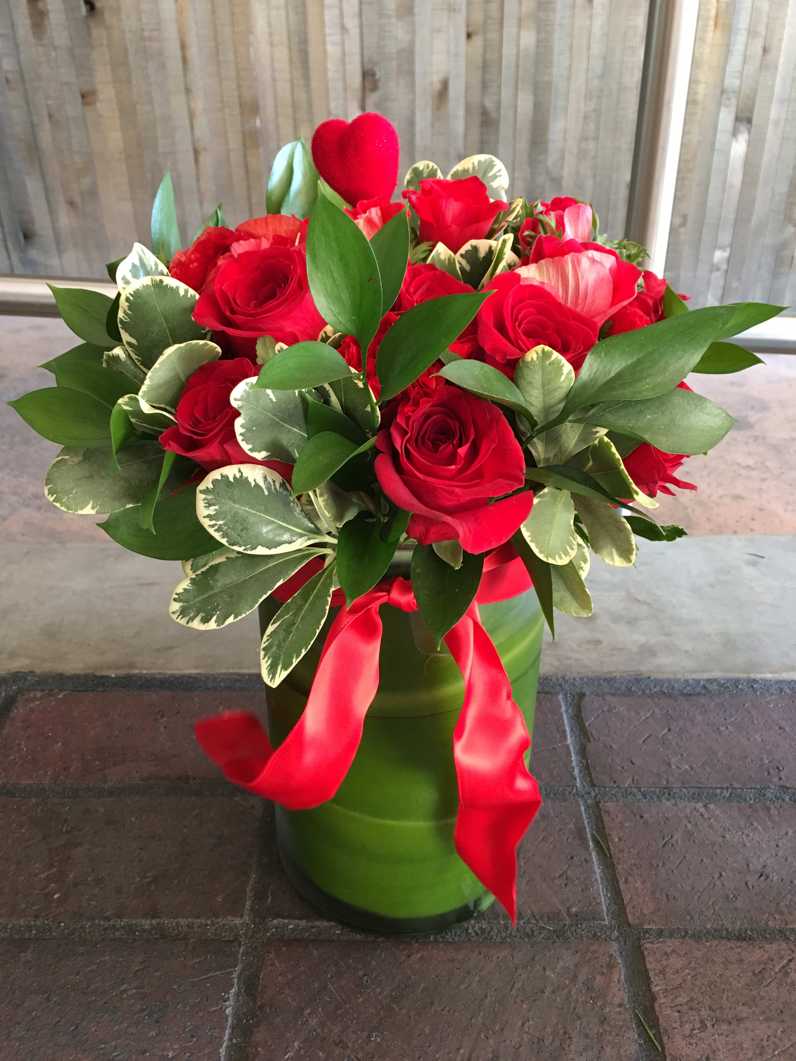 Classic Red - Red roses with pretty fillers wrapped in tea leaves arranged in cylindrical glass vase.