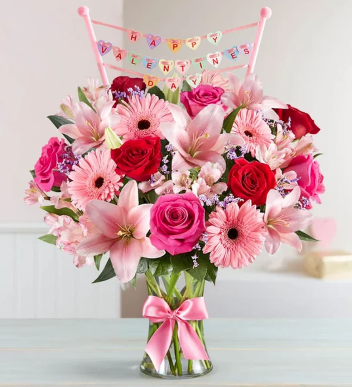 Fields of Europe® Romance with Valentine’s Day Banner™ Fields of Europe® Romance with Valentine’s Day Banner™ - Inspired by the rich beauty of the European countryside, our romantic bouquet reveals the feelings you have in your heart. Fresh-picked pink and red blooms are on display inside a glass vase finished with ribbon and topped with a banner declaring “Happy Valentine’s Day,” creating a gift they’ll long remember.