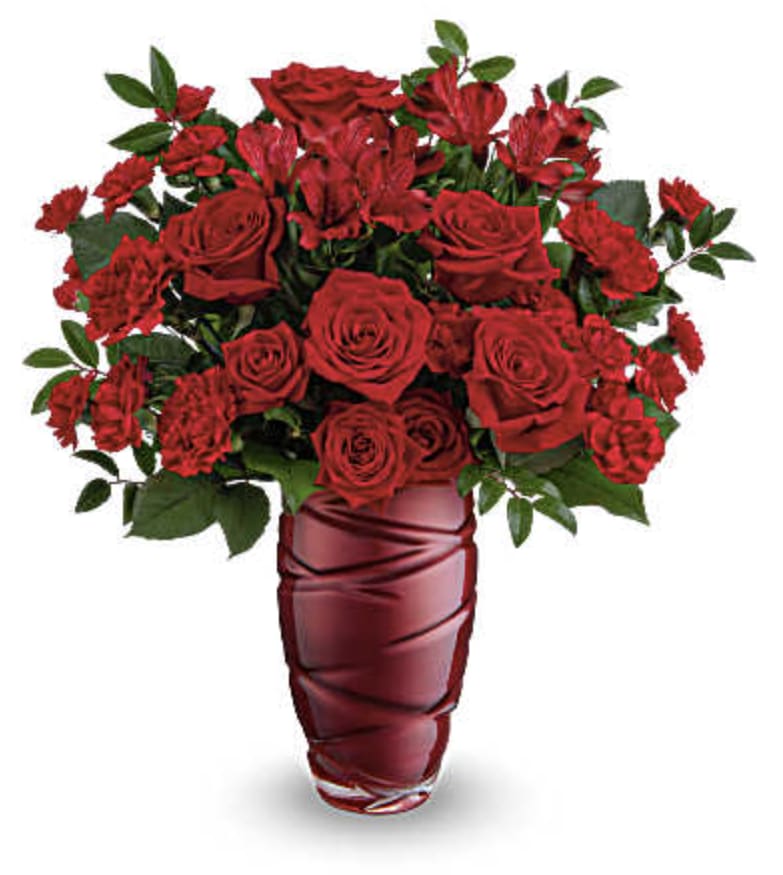 Love Blossoms Bouquet - Express your feelings boldly with this striking Valentine's Day bouquet of stunning red roses, elegantly arranged in a pearlescent glass vase featuring a captivating swirling design.