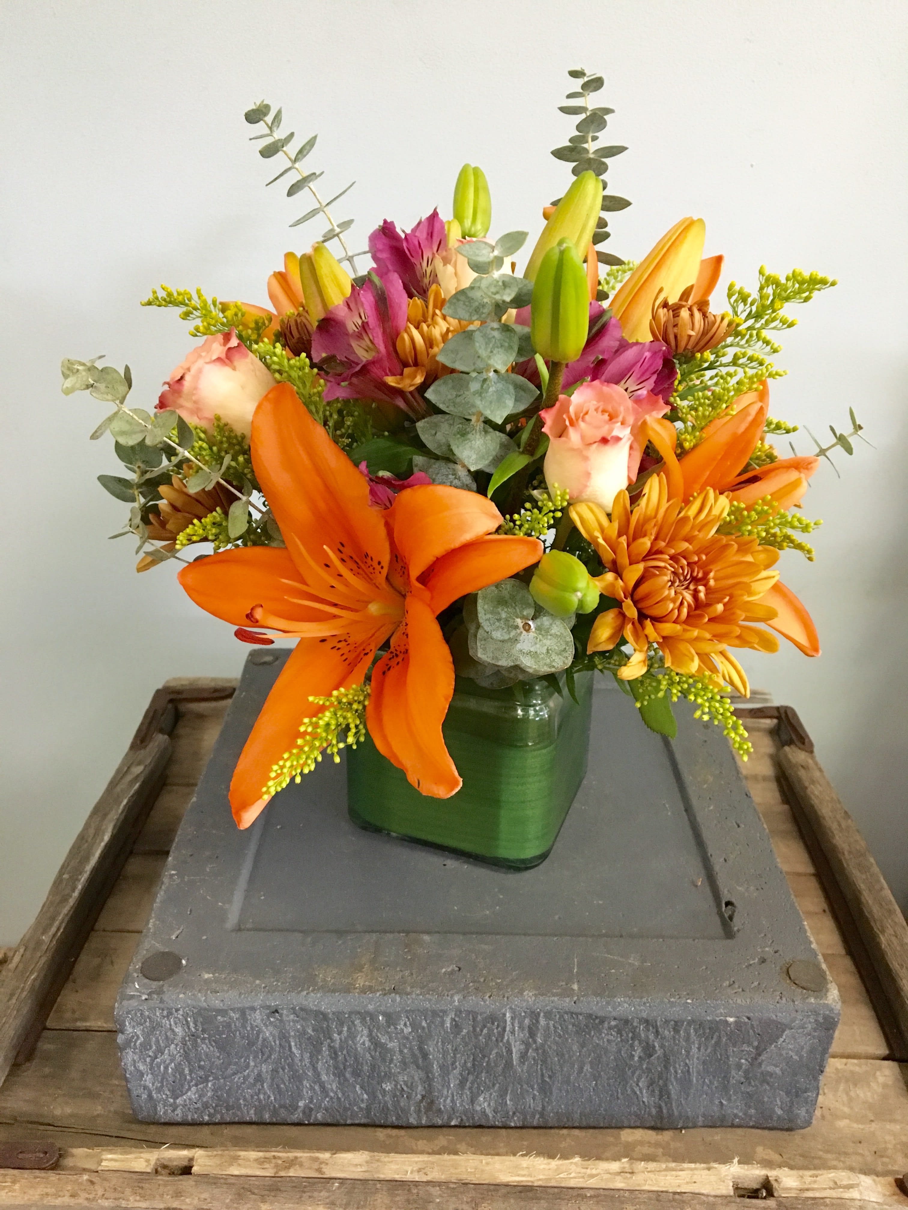 Simply Fall Simply Fall - A beautiful Autumn arrangement including asiatic lilies, roses, alstroemeria, poms, and eucalyptus designed in a leaf-wrapped short cube.