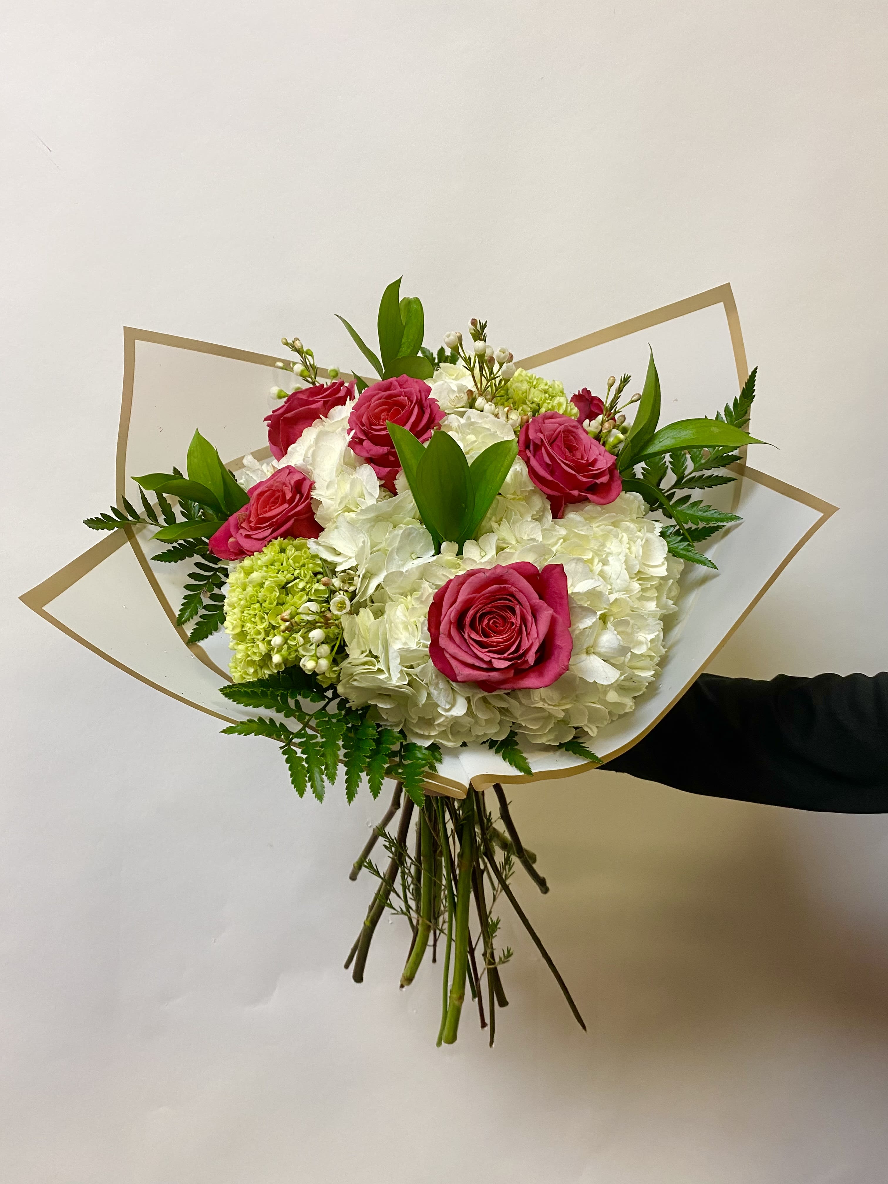 Mixed Bouquet Wrap - Our Mixed Flower Bouquet Includes White Hydrangeas, Roses, Mini Green Hydrangeas, Filler Flower and Greenery. Vase is Not Included  Write the Color of Roses you Prefer in the Special Instructions During Checkout Color Options: Red, Hot Pink, Light Pink, Lavender, Orange, Yellow and White 