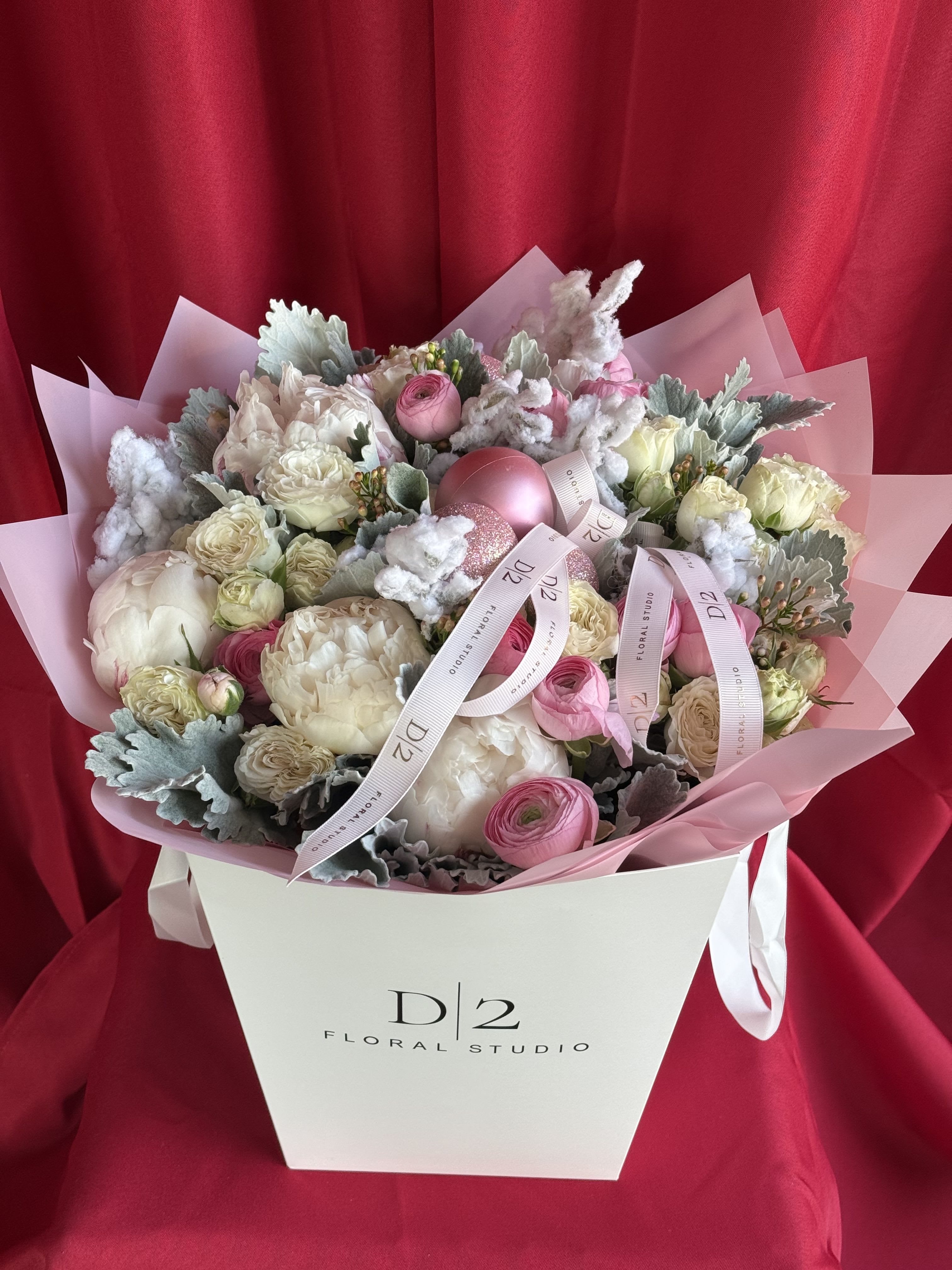 Festive Elegance Festive Elegance - Introducing our enchanting Christmas bouquet, a delicate blend of light whites and soft pinks that embodies the spirit of the season