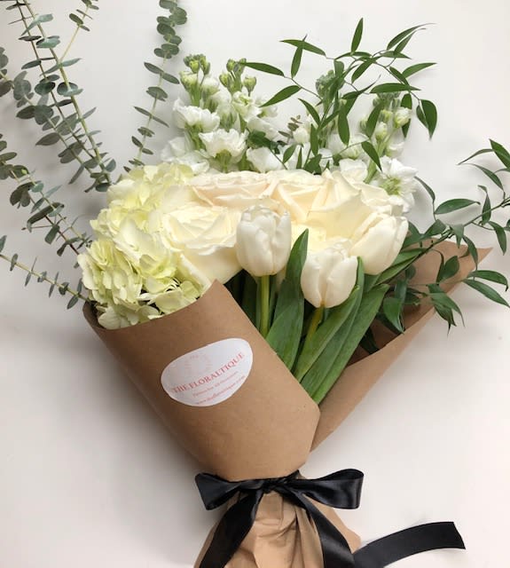 A Rustic Bunch - An earthy bouquet of dutch tulips, white roses and hydrangea accented with the fabulous aroma of fresh eucalyptus and a mix of lush greens.  The perfect mix for any occasion that is sure to brighten up any day. 