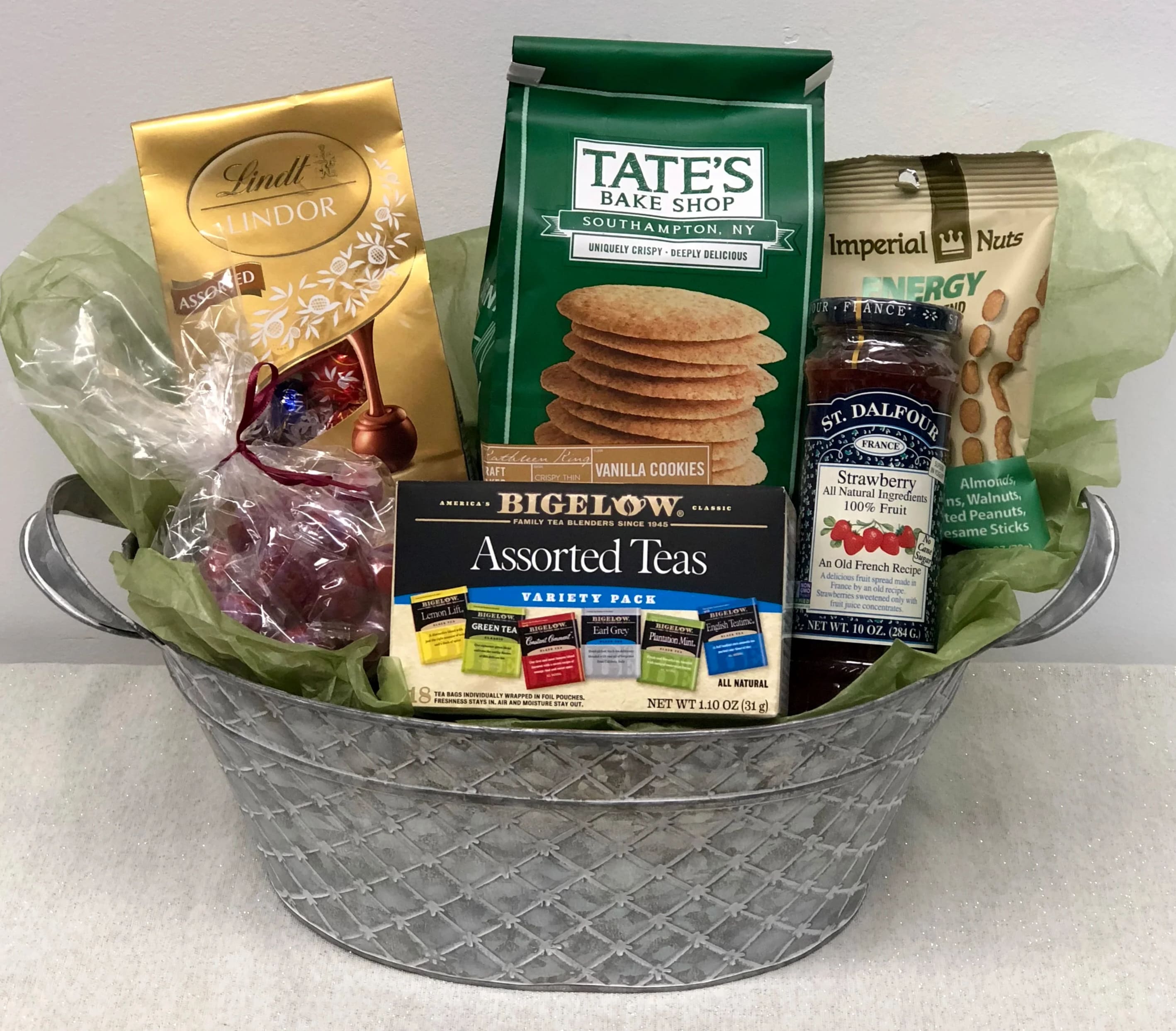 Gourmet Basket - Bake shop local cookies, energy assorted nut mix, truffles, hard candies, fruit preserves and a box of assorted tea in a metal tin or basket.  