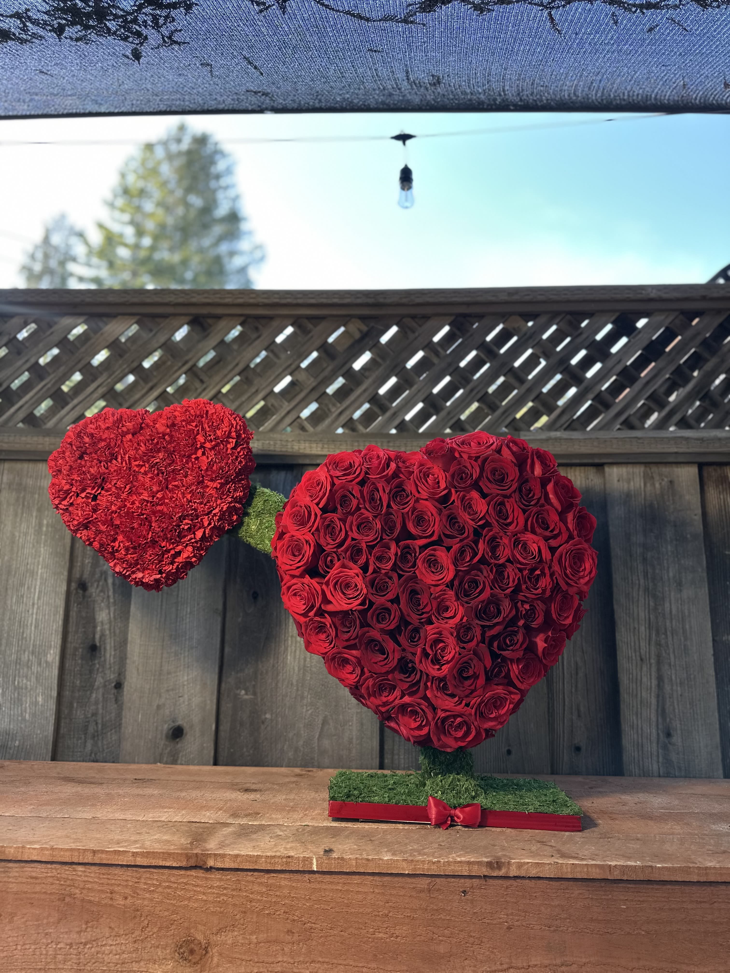 100 Red Roses standing Arrangement by Pretty Petals Arrangements  - 100 Red Roses Standing Arrangement by Pretty Petals Arrangements  Elevate any occasion with the timeless elegance of our 100 Red Roses Standing Arrangement**. Crafted with precision and passion by Pretty Petals Arrangements, this stunning floral masterpiece is the epitome of romance, sophistication, and luxury.    Each arrangement features **100 premium, handpicked red roses**, symbolizing deep love and admiration. The roses are expertly arranged in a tall, standing design, creating a dramatic and eye-catching display perfect for weddings, anniversaries, grand celebrations, or as a heartfelt gesture for someone special.    Presented in a stylish vase or container, this arrangement is designed to make a lasting impression. Whether it’s a centerpiece for a grand event or a meaningful gift, the **100 Red Roses Standing Arrangement** exudes opulence and charm.    **Why Choose This Arrangement?**   - **100 long-stemmed red roses** of the highest quality   - Elegant standing design for a striking visual impact   - Perfect for weddings, anniversaries, or grand gestures   - Handcrafted with care by Pretty Petals Arrangements    Make your moments unforgettable with the breathtaking beauty of 100 red roses. Order now and let Pretty Petals Arrangements help you express your deepest emotions in the most exquisite way.